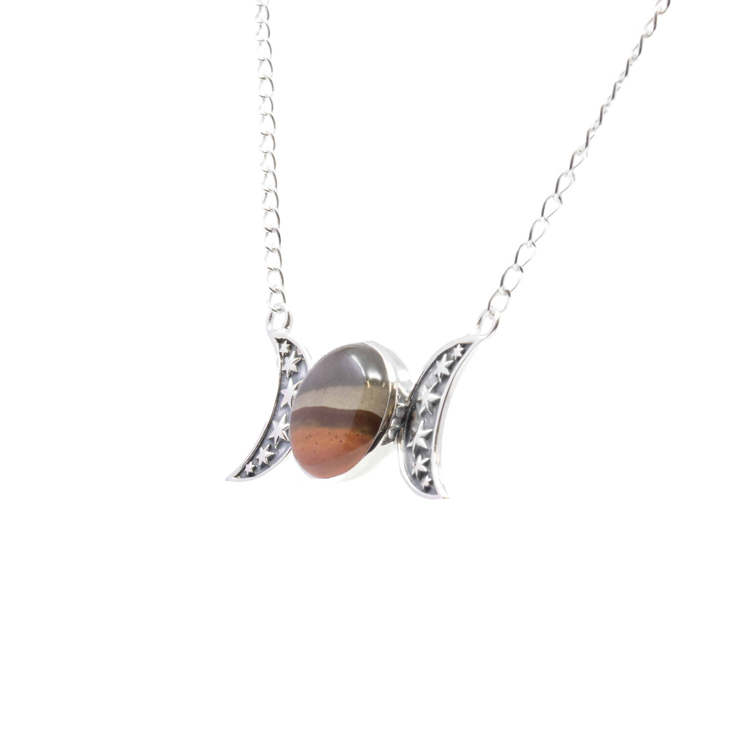 Introducing our exquisite Polychrome Jasper Necklace, a stunning piece that effortlessly combines nature's artistry with celestial elegance. This unique necklace features a mesmerizing round cabochon of Polychrome Jasper, known for its swirling hues reminiscent of sunlit deserts and vibrant landscapes. Each stone is one-of-a-kind, showcasing a palette of earthy tones that promise to captivate and inspire.The jasper cabochon is securely nestled in a simple yet elegant bezel setting, highlighting its natural beauty while ensuring durability. Adding a touch of cosmic charm, the necklace is adorned with two 925 sterling silver moons, each intricately stamped with delicate stars at the center. These celestial accents bring a mystical allure to the piece, symbolizing balance and harmony. Polychrome Jasper Necklace - Round Cabochon with Simple Bezel & 2 925 Sterling Silver Moons with Stars Stamped in Center