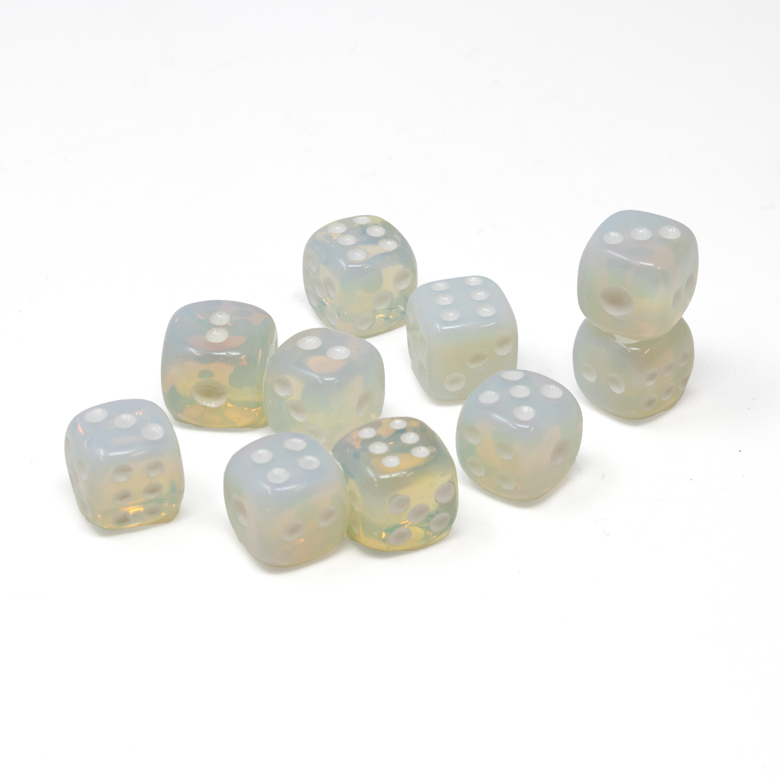 Unleash the mystical allure of your gaming experience with our exquisite Opalite Carved Dice Set. This carefully crafted set of ten dice is designed to captivate the eyes and ignite the imagination, making it a perfect gift for both him and her.Each die is meticulously carved from high-quality opalite, known for its enchanting play of color that reflects a mesmerizing blend of iridescent blues and soft whites. Opalite Carved Dice Set of 10