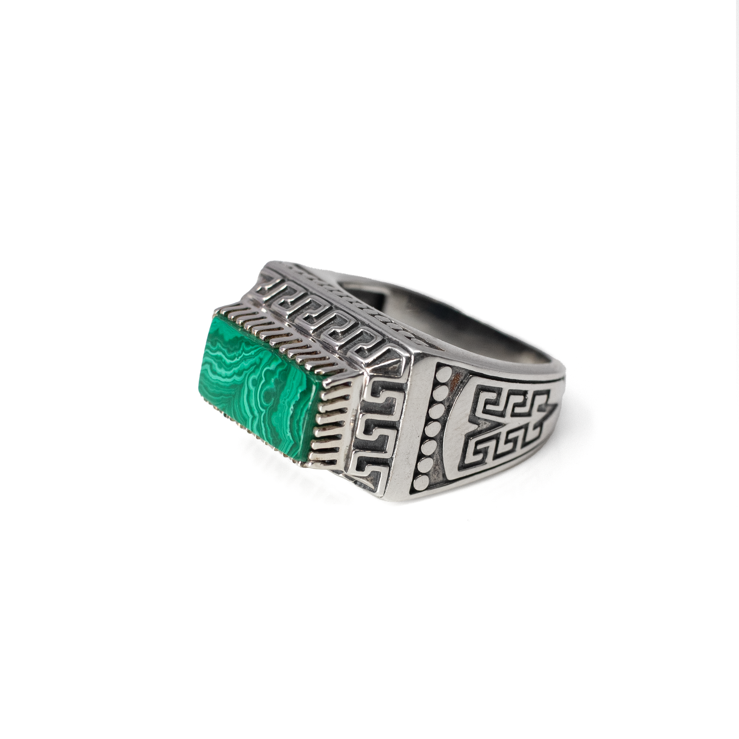 Discover timeless elegance with our Malachite Ring, featuring a striking flat cut East-West set rectangle of vibrant malachite. This exquisite gem showcases the rich, swirling greens characteristic of malachite, capturing attention and sparking conversation wherever you go. The gemstone is beautifully set on a 925 sterling silver signet-style band, ensuring durability and shine that can withstand the demands of everyday wear.The band is adorned with an intricate Aztec design, adding a touch of historical and cultural depth to the piece. This artful embellishment not only enhances the ring’s aesthetic appeal but also pays homage to ancient craftsmanship, making it a unique addition to any jewelry collection.Crafted specifically for women, this ring is a size 9, striking the perfect balance between style and comfort. It seamlessly transitions from day to night, making it an ideal accessory for both casual and formal outfits. Whether you're adding a statement piece to your jewelry ensemble or searching for a thoughtful gift, the Malachite Ring is a stunning choice that embodies both modern elegance and ancient allure. Malachite Ring - Flat Cut East-West Set Rectangle Set on 925 Sterling Silver Signet Style Band with Aztec Design sz9
