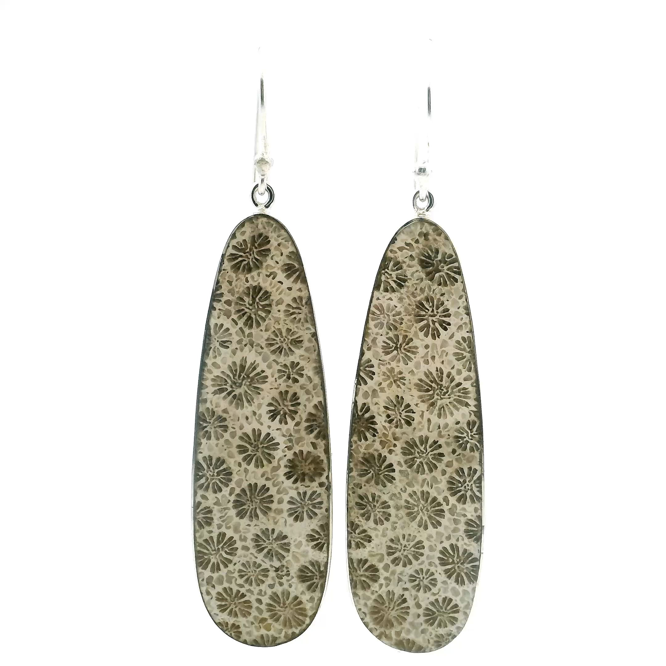 These Fossilized Coral Dangle Earrings feature elongated oval cabochons, each revealing the ancient floral patterns naturally etched into the stone over millennia. Set in sleek 925 sterling silver bezels, the earrings strike a refined balance between organic texture and polished design. Their graceful dangle adds subtle movement, catching light and drawing the eye to the intricate detail within each fossil.Elegant yet earthy, these earrings offer a unique way to wear a piece of geological history. Whether worn as a quiet statement or a thoughtful gift, they evoke timeless beauty shaped by nature and preserved in silver. Fossilized Coral Dangle Earrings - Elongated Oval Cabochon with 925 Sterling Silver Bezel