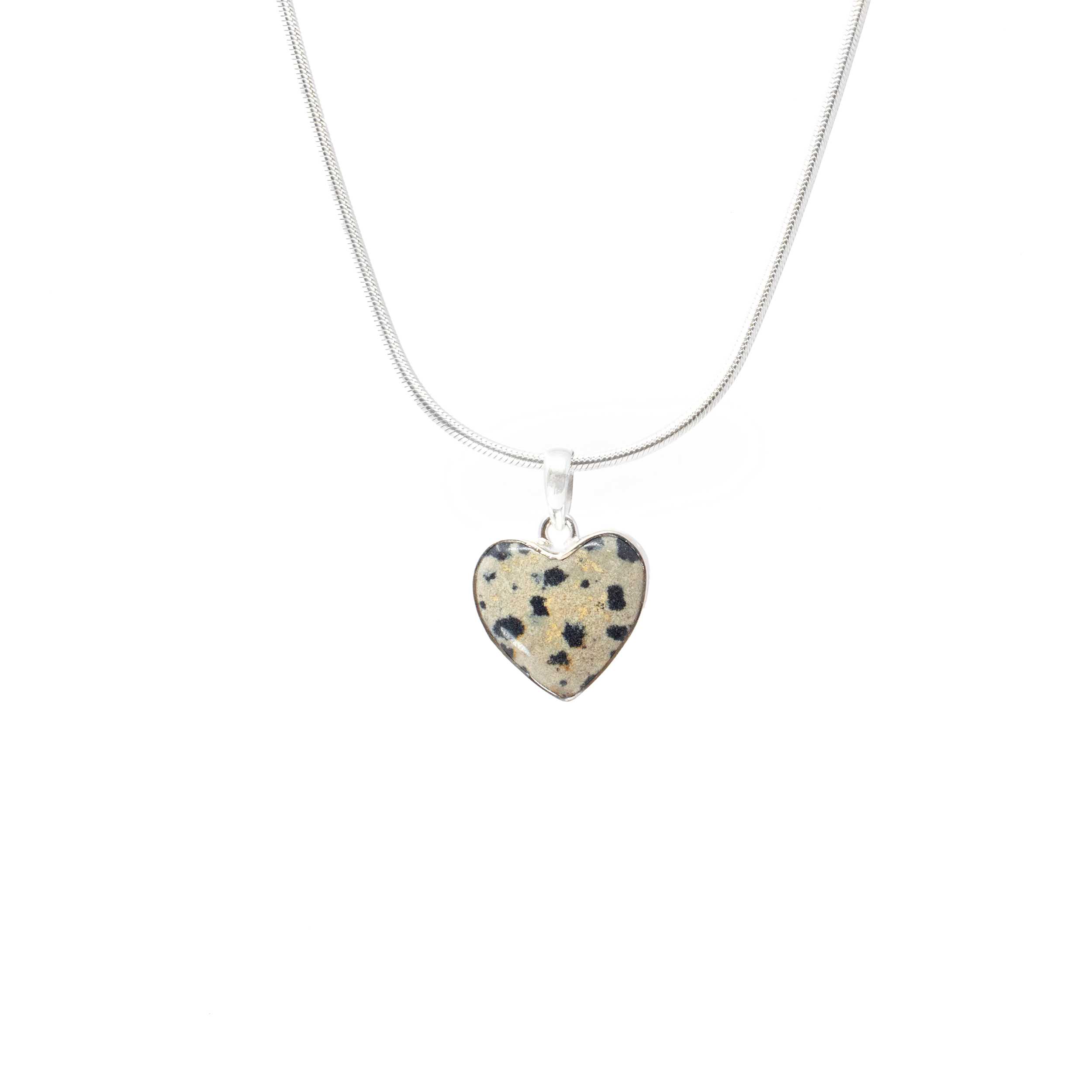 Introducing our exquisite Dalmatian Jasper Pendant, featuring a dainty heart-shaped cabochon that beautifully captures the unique pattern of this enchanting stone. Nestled in a simple yet elegant 925 sterling silver bezel, this pendant offers an exquisite blend of sophistication and natural beauty, making it a must-have addition to any jewelry collection.The heart-shaped Dalmatian Jasper stone showcases its signature black and brown spots, ensuring that each pendant is one-of-a-kind. Expertly set in a 925 sterling silver bezel, the pendant is crafted to highlight the stone's natural beauty while offering durability and elegance.Chain Not Included. Dalmatian Jasper Pendant - Dainty Heart Cabochon with Simple 925 Sterling Silver Bezel