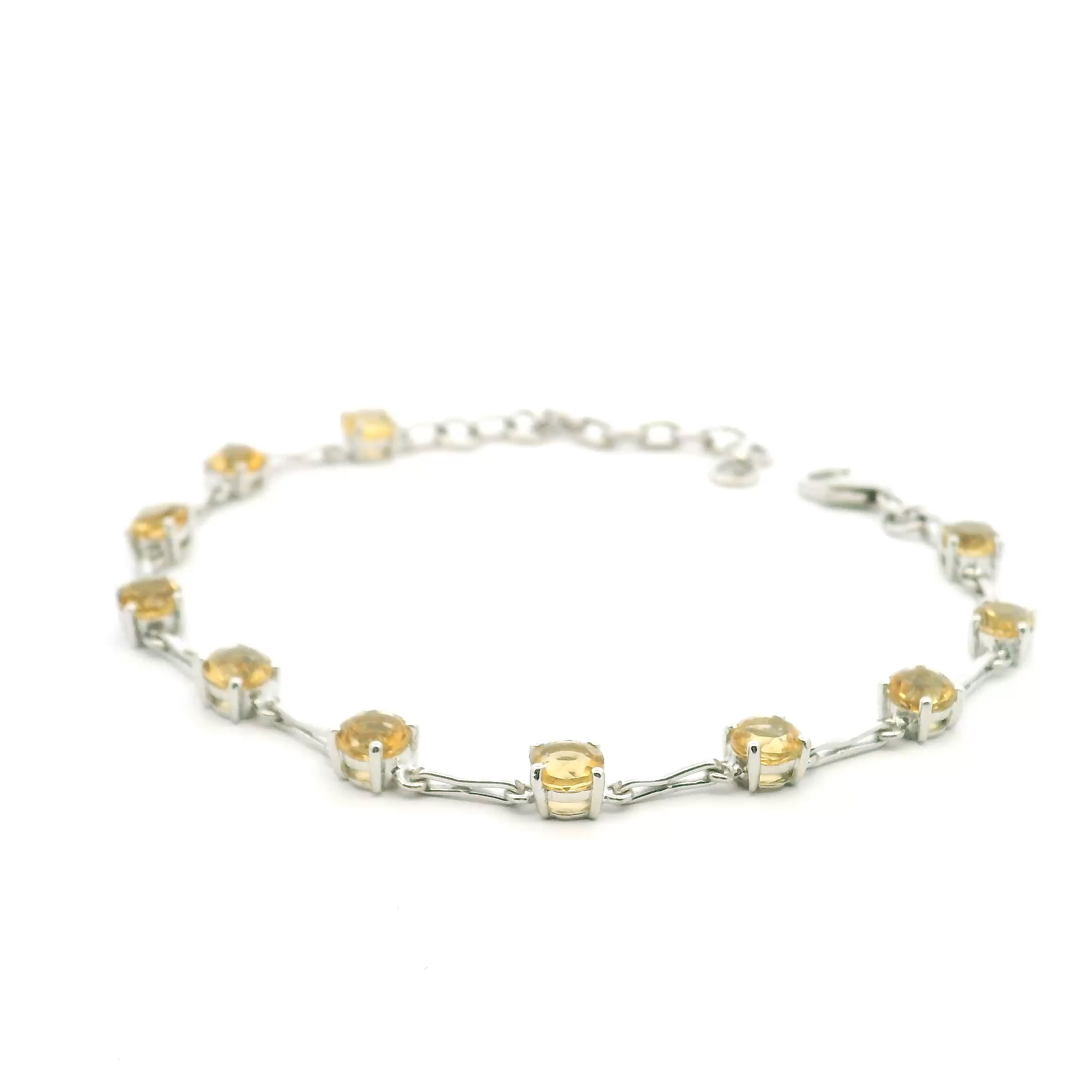 Illuminate your style with our Faceted Citrine Link Bracelet. Featuring 11 radiant 5mm citrine gemstones, each prong-set to maximize brilliance, this bracelet pairs vibrant golden hues with sleek 925 sterling silver bar links. Elegant yet modern, it's a versatile piece that effortlessly elevates both everyday looks and special occasions. A timeless blend of craftsmanship and natural beauty, perfect as a gift or personal treasure. Faceted Citrine Link Bracelet - 11 5mm Rounds Prong Set with 925 Sterling Silver Bar Links In Between