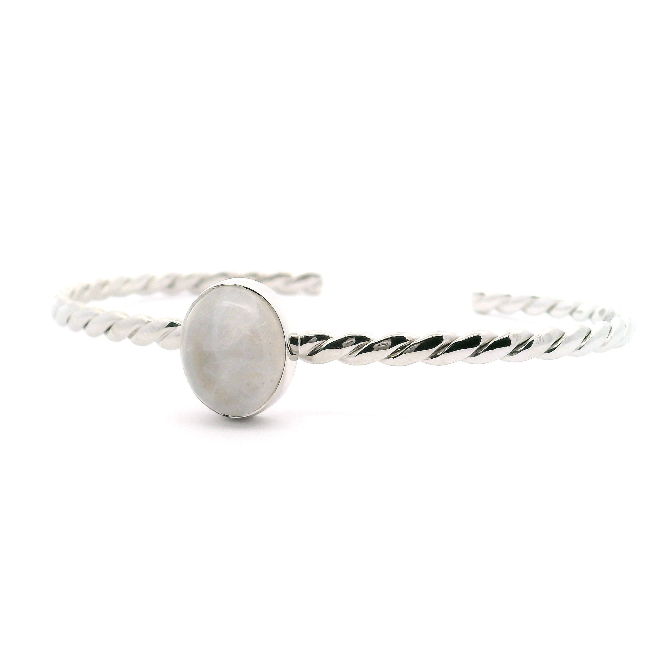 Illuminate your style with this enchanting Rainbow Moonstone Cuff Bracelet, masterfully crafted for the modern woman. A mesmerizing oval cabochon of natural rainbow moonstone sits at center stage, bezel-set to showcase its ethereal play of color. The genuine 925 sterling silver band features a classic rope design, adding timeless texture and sophistication. Easily adjustable for a comfortable fit, this bracelet radiates feminine elegance—perfect for stacking or as a striking standalone piece. Rainbow Moonstone Cuff Bracelet - Oval Cabochon Bezel Set on 925 Sterling Silver Rope Band