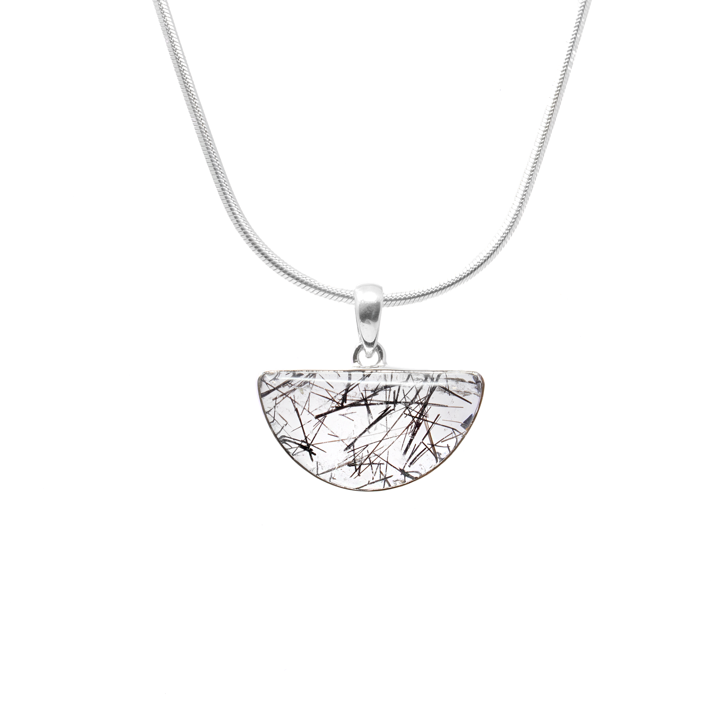 Add a touch of elegance and mystique to your jewelry collection with our Black Tourmaline Rutile Pendant. This exquisite piece features a unique half-circle cabochon that beautifully showcases the intricate patterns of rutilated black tourmaline, known for its striking natural inclusions. The pendant is elegantly set in a simple yet sophisticated 925 sterling silver bezel, highlighting the stone's natural beauty while offering a polished and timeless look.Perfect for women who appreciate the charm of artisanal jewelry, this pendant embodies both style and substance. Known for its protective and grounding properties, black tourmaline is not only a stunning piece of jewelry but also a meaningful accessory for daily wear. Whether paired with a casual outfit or a more refined look, this pendant adds a touch of luxury and allure to any ensemble. Black Tourmaline Rutile Pendant - Half Circle Cabochon with Simple 925 Sterling Silver Bezel