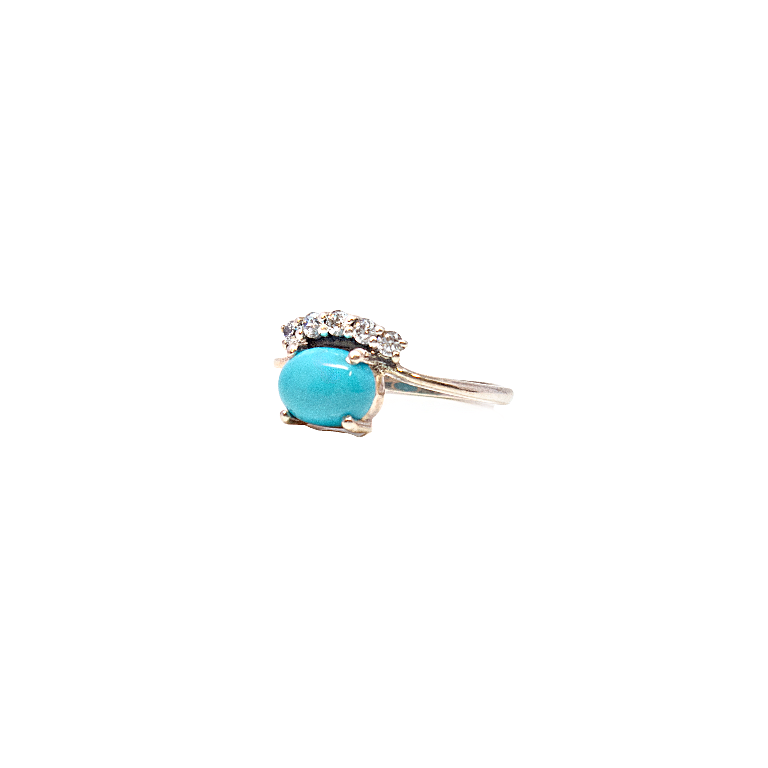 Elevate your jewelry collection with this stunning Turquoise Ring, featuring an exquisite oval cabochon turquoise gemstone, meticulously prong-set to showcase its natural beauty. The vibrant turquoise, with its unique matrix and bold color, is elegantly complemented by sparkling white cubic zirconias, which add a touch of brilliance and sophistication.Crafted on a solid 925 sterling silver band, this ring boasts a vertical design that highlights the harmonious blend of gemstones and precious metal. The sterling silver band is not only durable and hypoallergenic but also provides a lustrous finish that enhances the ring's overall allure. Turquoise Ring - Oval Cabochon Prong Set with White Czs on 925 Sterling Silver Vert Band sz8