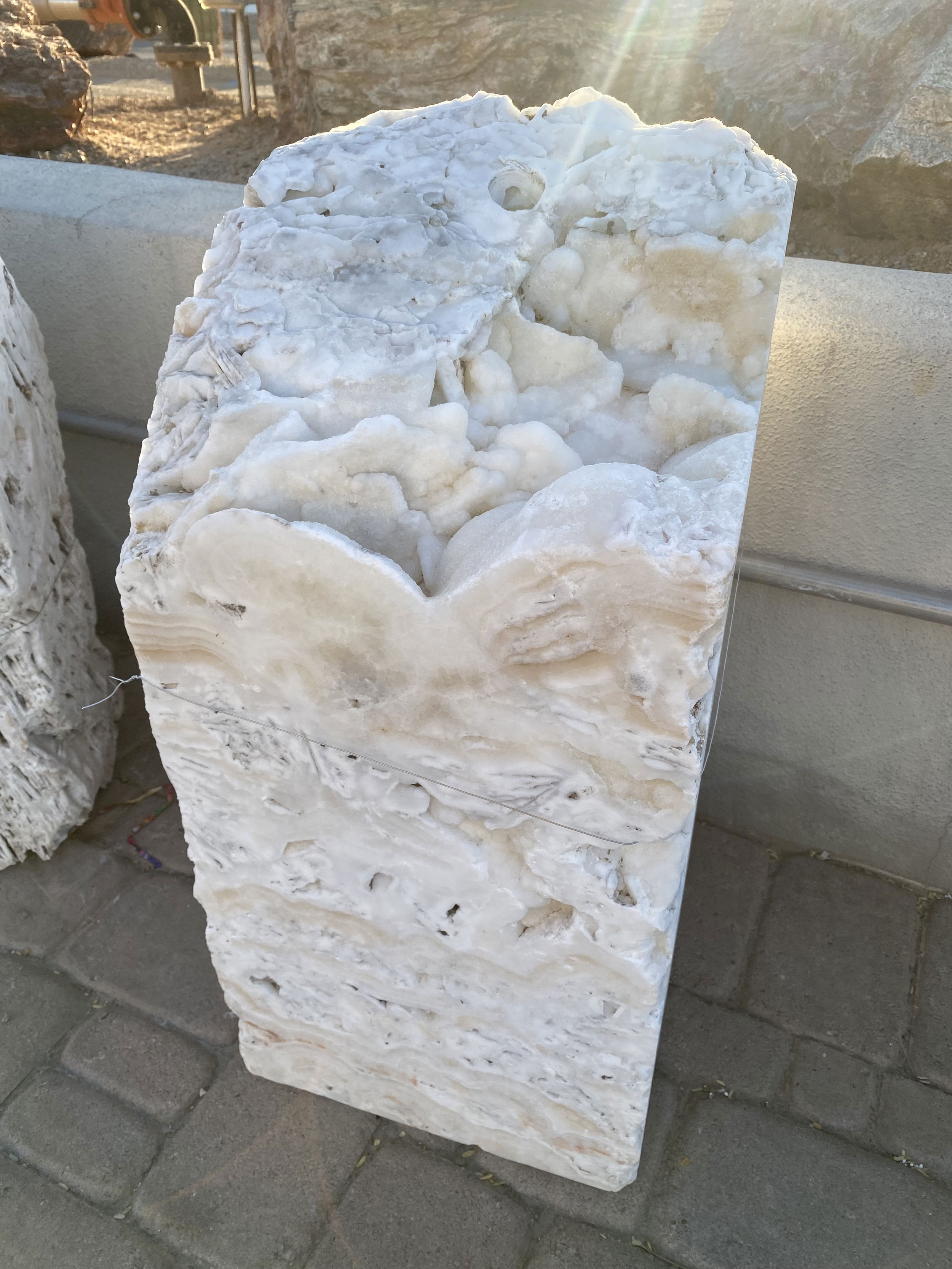 Elevate the ambiance of your space with the exquisite White Fossil Onyx Fountain - Block with Natural Top, a masterpiece in both design and functionality. This stunning fountain, blends natural beauty with an element of tranquility, making it a perfect addition to any indoor or outdoor setting.Let Rare Earth Gallery’s white-glove service make your fountain dreams come true—simply choose your fountain, tell us where it goes, and we’ll handle the rest, from delivery to installation. IMPORTANT: the purchase price listed is for the FOUNTAIN ONLY and DOES NOT INCLUDE the cost of a basin, pump, parts or installation. Before purchasing a fountain online, we STRONGLY recommend you call us at (480) 575-4360 for a FREE consultation to discuss these additional costs and schedule a pre-site inspection. Also, free shipping does NOT apply to fountains, please call for a quote. White Fossil Onyx Fountain - Block with Natural Top