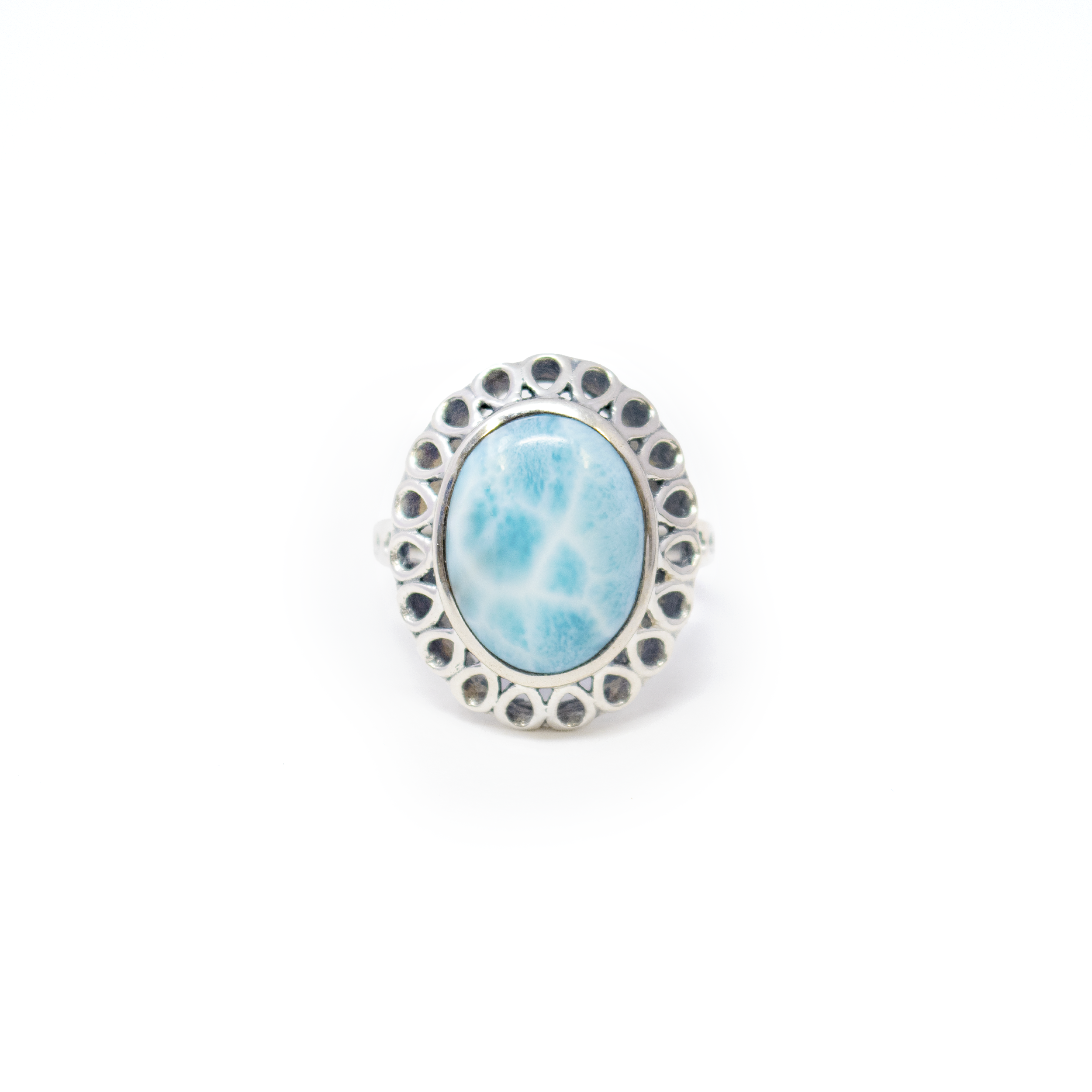 Elevate your jewelry collection with the captivating beauty of the Larimar Ring, a stunning piece that embodies both elegance and natural charm. This exquisite ring features an oval cabochon of mesmerizing larimar, renowned for its serene blue hues reminiscent of tranquil ocean waters. Crafted with precision, the larimar is set in a high-quality 925 sterling silver bezel, ensuring durability while accentuating the stone's natural beauty. The ring's design is further enhanced by pear cutouts along the edge and band top, adding a touch of sophistication and modern flair to this timeless piece. Larimar Ring - Oval Cabochon Set in 925 Sterling Silver Bezel with Pear Cutouts Around Edge & Band Top sz6