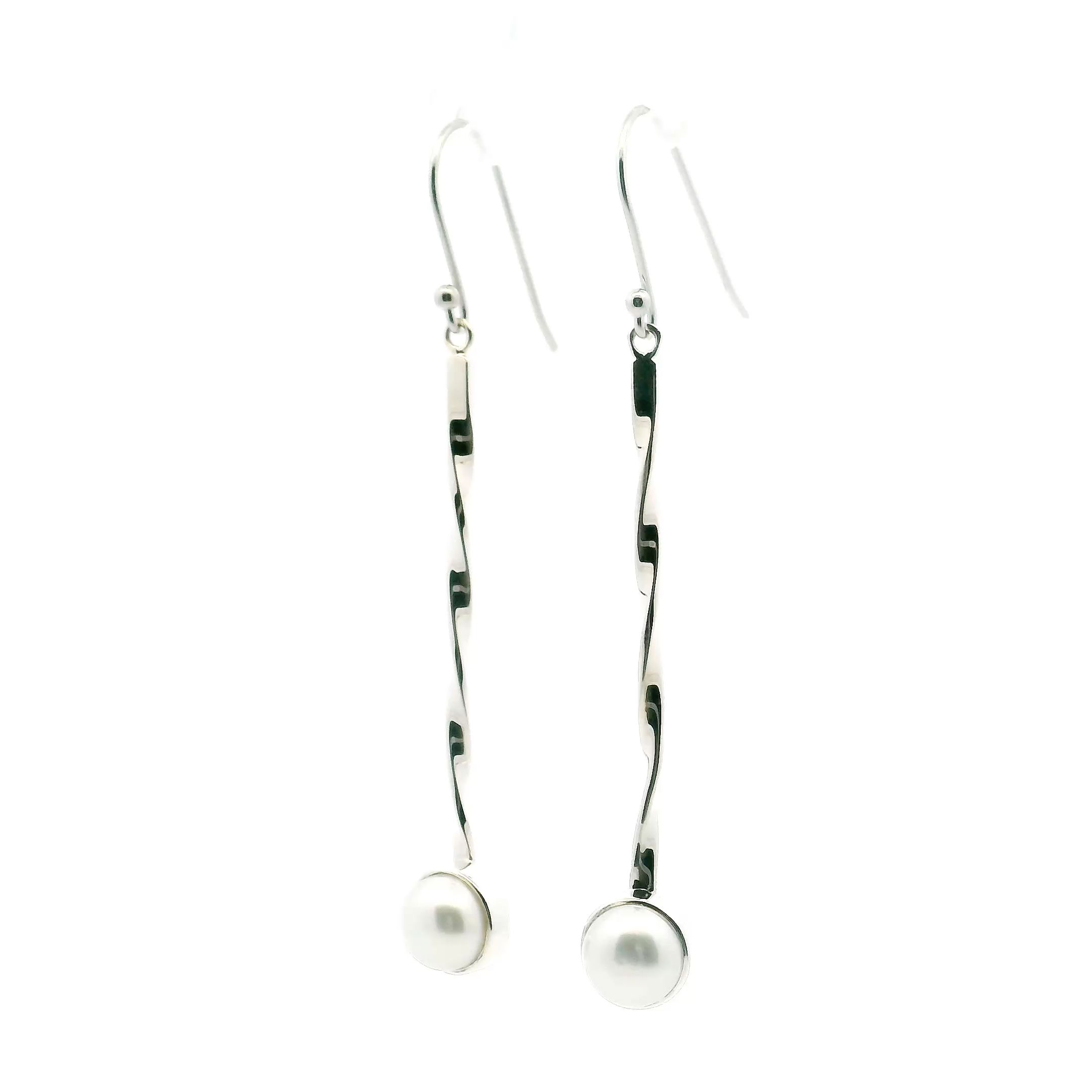 Elevate your style with our Freshwater Pearl Dangle Earrings. A luminous round pearl, bezel-set in 925 sterling silver, hangs from a 2-inch twisted silver rod that catches the light with every move. Elegant yet modern, these earrings add a timeless touch to both everyday looks and special occasions, making them a refined addition to any jewelry collection. Freshwater Pearl Dangle Earrings - Round Pearl Bezel Set in 925 Sterling Silver at End of 2" Silver Twisted Rod