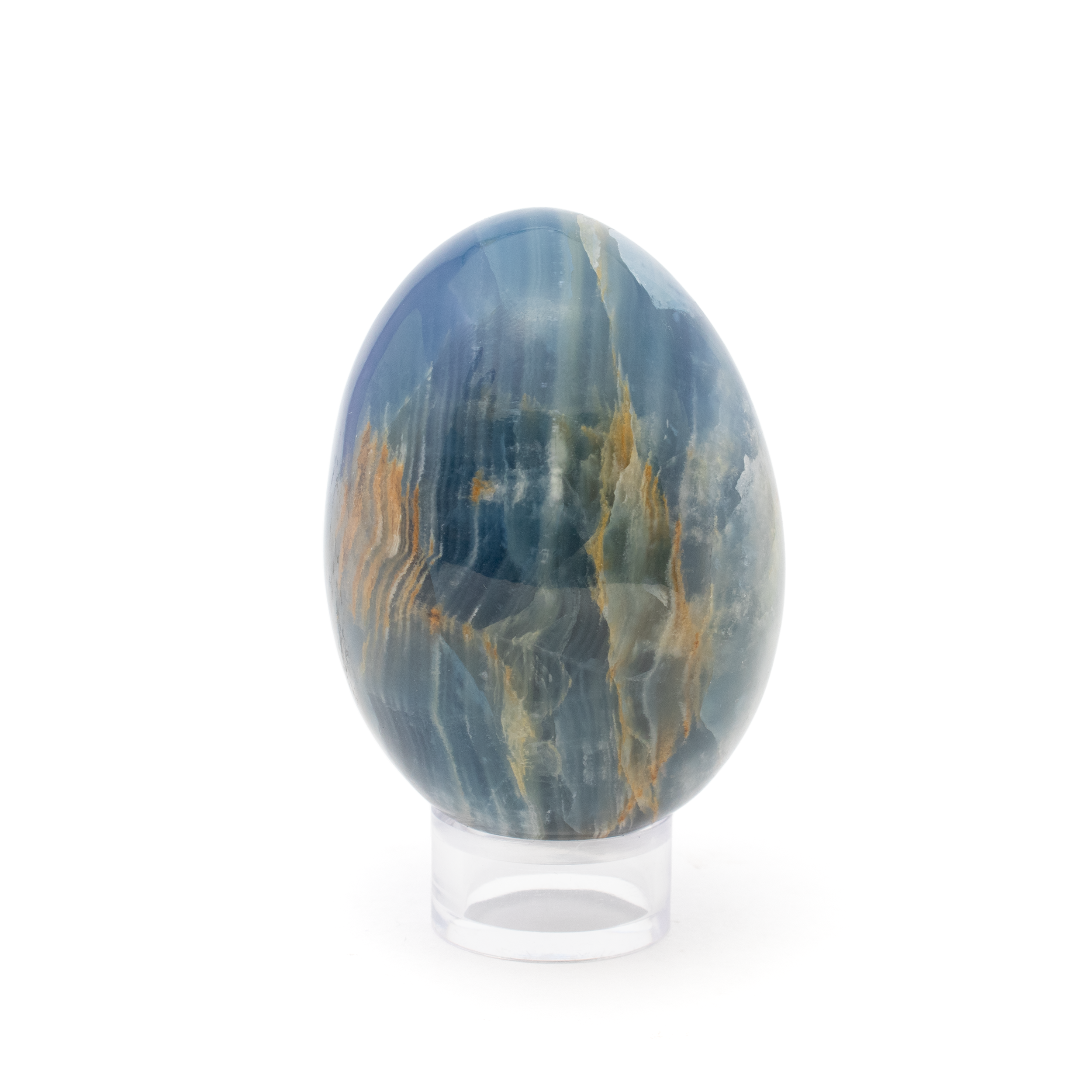 Discover the enchanting allure of our A+ Argentinian Blue Calcite Egg, a captivating piece that harmonizes natural beauty with elegant design. This meticulously crafted egg-shaped crystal showcases the soothing, serene hues of blue calcite, a mineral renowned for its calming energy and aesthetically soothing appeal. Straight from the mineral-rich lands of Argentina, this exquisite specimen is a testament to nature's artistry.The egg form is traditionally associated with new beginnings and a symbol of fertility, making it a thoughtful addition to any space where regeneration and growth are cherished. The smooth, polished surface of the egg highlights the unique, swirling patterns and gentle gradients of sky and ocean blues, adding a touch of tranquility to your living area, workspace, or meditation corner. A+ Argentinian Blue Calcite Egg with Lucite Ring Stand