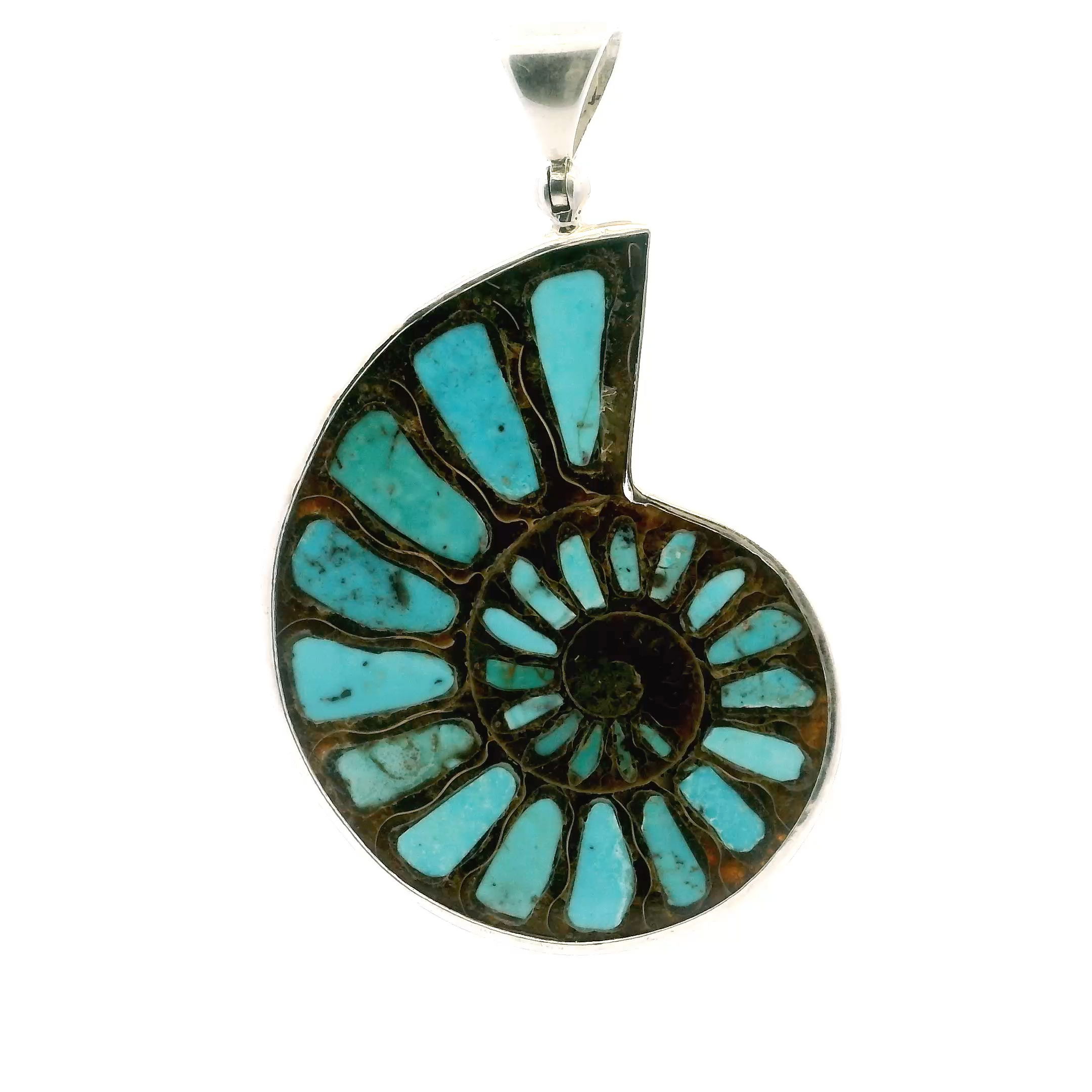 Celebrate timeless beauty with our Ammonite Fossil Pendant. Featuring an open cross-section of a 100-million-year-old fossil inlaid with robin’s egg blue Arizona turquoise, each piece is bezel-set in 925 sterling silver for lasting elegance. A striking blend of color, texture, and history, this pendant is perfect for women who appreciate meaningful, one-of-a-kind jewelry for any occasion. Ammonite Fossil Pendant - Open Ammonite Cross-section Inlaid with Robins Egg Blue Arizona Turquoise Bezel Set in 925 Sterling Silver