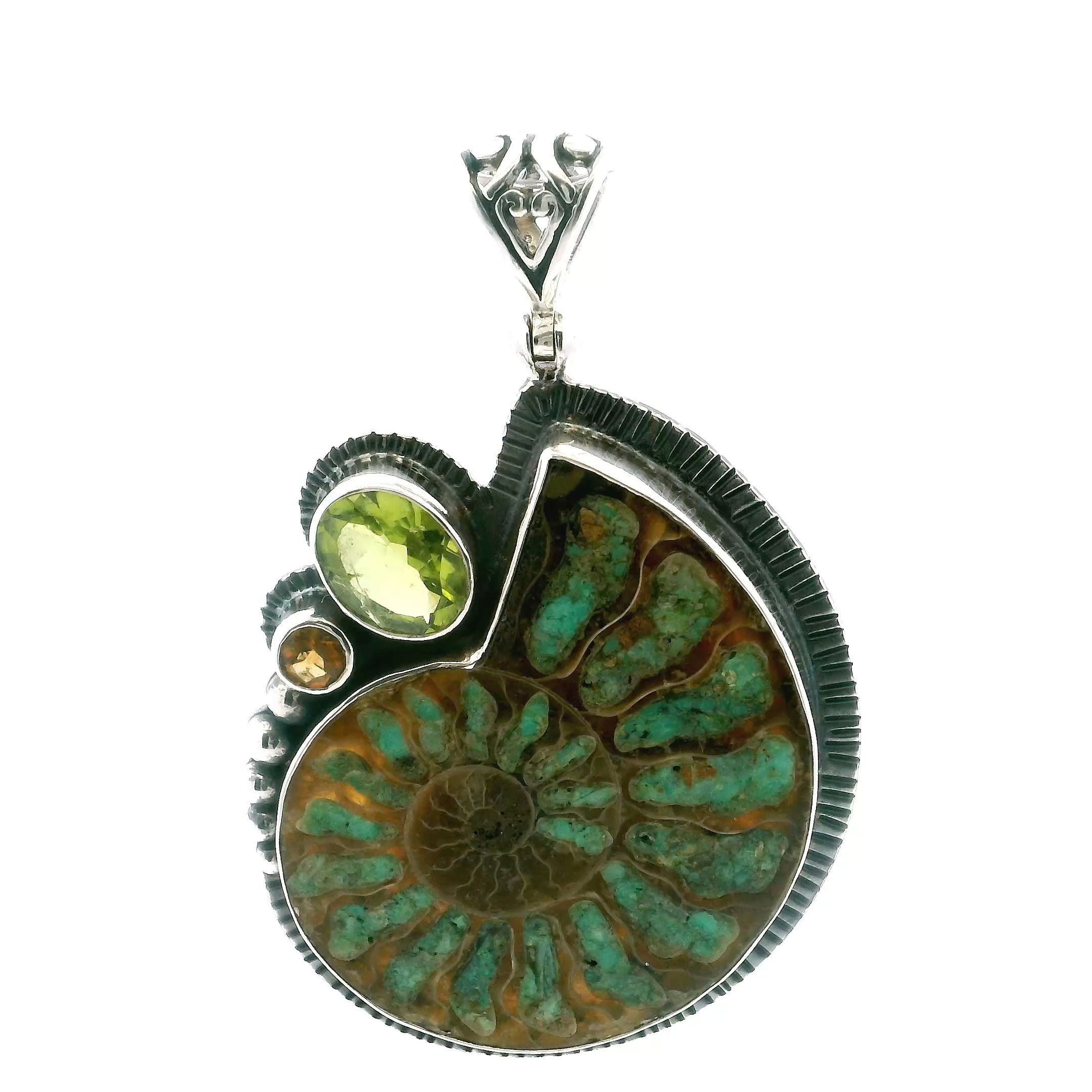 Discover timeless natural beauty with our Ammonite Fossil Pendant. Featuring an open ammonite cross-section inlaid with vibrant smithsonite, this piece is accented by a lush green peridot and a golden citrine, both bezel-set for brilliant sparkle. Crafted in 925 sterling silver with intricate bead and line details, it blends ancient artistry with modern elegance. Perfect for women who appreciate rare, meaningful jewelry, this pendant is a captivating addition to any collection. Ammonite Fossil Pendant - Open Ammonite Cross-section Inlaid with Smithsonite with Faceted Peridot Oval & Citrine Round Bezel Set in 925 Sterling Silver with Bead & Line Accents
