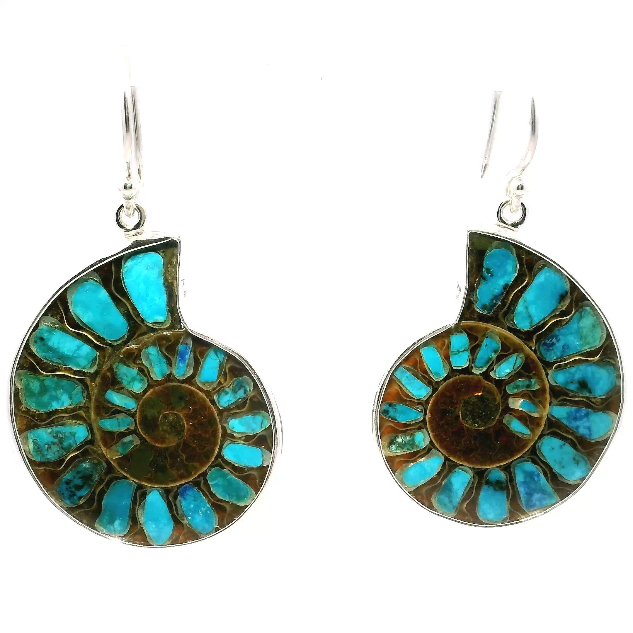 Discover the perfect fusion of natural history and contemporary style with our Ammonite Fossil Dangle Earrings. Each pair features a cross-section of genuine ammonite fossil, its mesmerizing spiral pattern inlaid with vibrant Shattuckite—a mineral prized for its deep blue-green tones that evoke the beauty of ocean and sky.Framed in a minimalist 925 sterling silver bezel, the design highlights the organic textures and brilliant colors of the materials without overpowering them. The earrings dangle elegantly, catching the light as they move and adding a refined, artistic touch to any ensemble. Whether worn casually or on special occasions, they offer just the right balance of boldness and elegance.More than just a piece of jewelry, these earrings are a tribute to Earth's ancient past—crafted for those who appreciate timeless design and natural wonder. Their one-of-a-kind composition makes them a thoughtful gift for collectors, nature lovers, or anyone who values jewelry with a story.Embrace the charm of ancient oceans and carry a piece of Earth’s history with you in every step. Ammonite Fossil Dangle Earrings - Cross-section Inlaid with Shattuckite & Bezel Set in Simple 925 Sterling Silver
