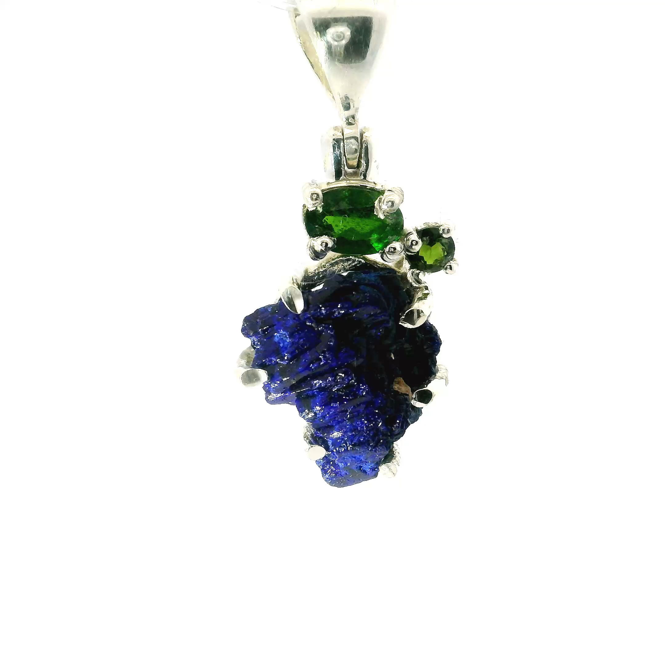 Featuring a one-of-a-kind azurite crystal, this pendant shines with deep blue hues and natural sparkle. Set in a sleek metal frame with an adjustable chain, it’s perfect for adding a touch of earthy sophistication to any look. Inspired by nature and known for enhancing intuition, it’s a piece that feels as powerful as it looks. Azurite Druze Pendant - Rough Speciman Prong Set with Faceted Chrome Diopside Oval & Round Prong Set in 925 Sterling Silver