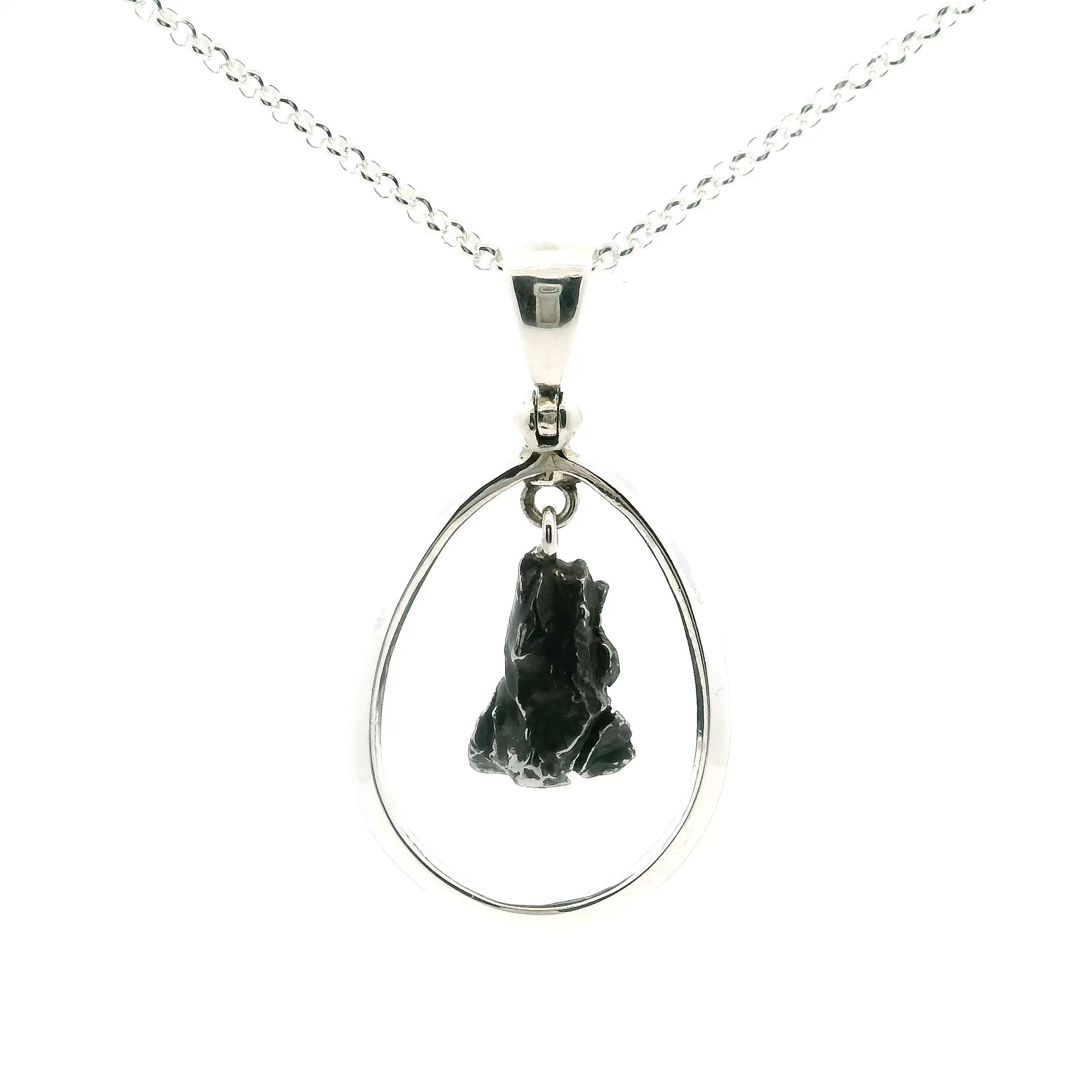 Celebrate your individuality with our Women’s Meteorite Pendant, crafted from genuine meteorite fragments—each with its own natural, one-of-a-kind pattern.Set in your choice of sterling silver or white gold, the stone’s crystalline texture catches the light and sparks curiosity, turning a simple necklace into a meaningful statement.Perfect for marking special moments or adding a cosmic touch to everyday wear, this pendant is designed for those who value rarity, elegance, and the beauty of the universe. Campo De Cielo Meteorite Pendant - Rough Speciman Hanging in Open Oval with 925 Sterling Silver with Chain