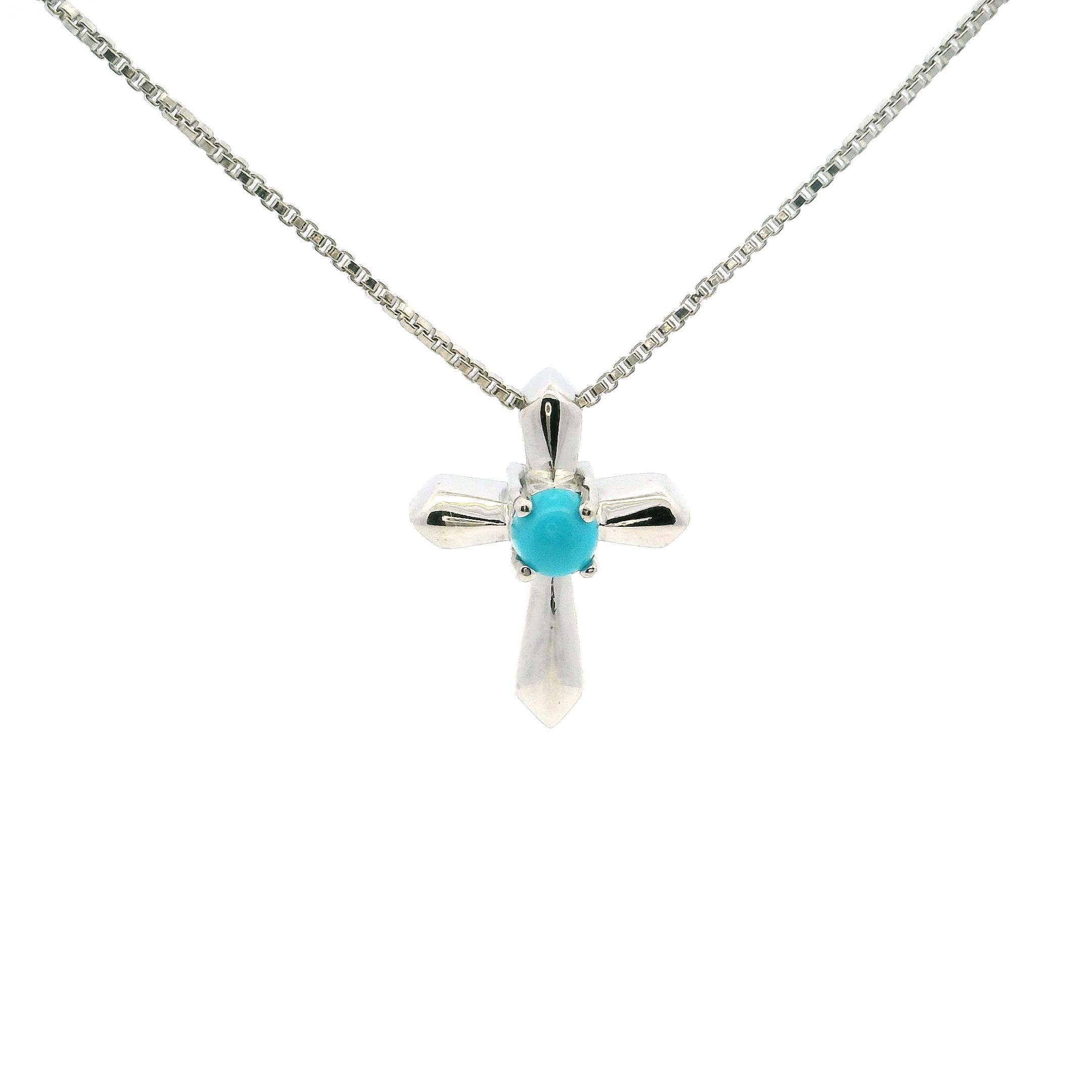 This New Mexican Turquoise Cross Necklace features a dainty round cabochon of natural turquoise, prong-set at the center of a simple 925 sterling silver cross. The stone’s blue-green hue and subtle matrix provide a soft yet striking focal point, radiating a calm, grounded energy.Suspended from a fine sterling silver chain with an adjustable length, the pendant sits gracefully against the skin, offering everyday comfort and versatility. A quiet statement of faith and style, this necklace blends timeless design with the raw beauty of Southwestern turquoise. New Mexican Turquoise Cross Necklace- Dainty Round Cabochon Prong Set in Simple 925 Sterling Silver with Chain