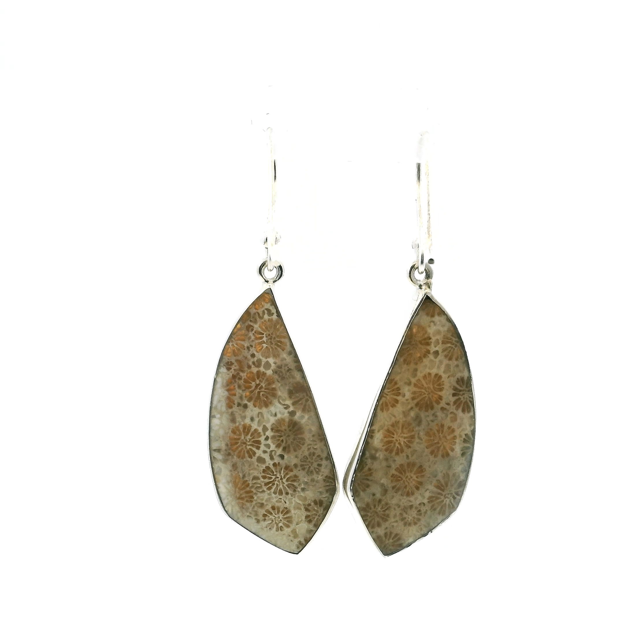 These Fossilized Coral Dangle Earrings feature tooth-shaped cabochons, each one a natural mosaic of ancient marine beauty captured in stone. Formed over millions of years, the fossilized coral reveals delicate, flower-like patterns in soft, earthy hues—each pair entirely unique. Bezel set in gleaming 925 sterling silver and suspended from graceful hooks, they offer subtle movement and timeless elegance.Refined yet organic, these earrings are perfect for women who value both artistry and meaning in their adornments. Whether worn casually or as a striking accent to formal wear, they add a touch of nature’s quiet wonder to any ensemble. Fossilized Coral Dangle Earrings - Tooth Shape Cabochon Bezel Set in 925 Sterling Silver