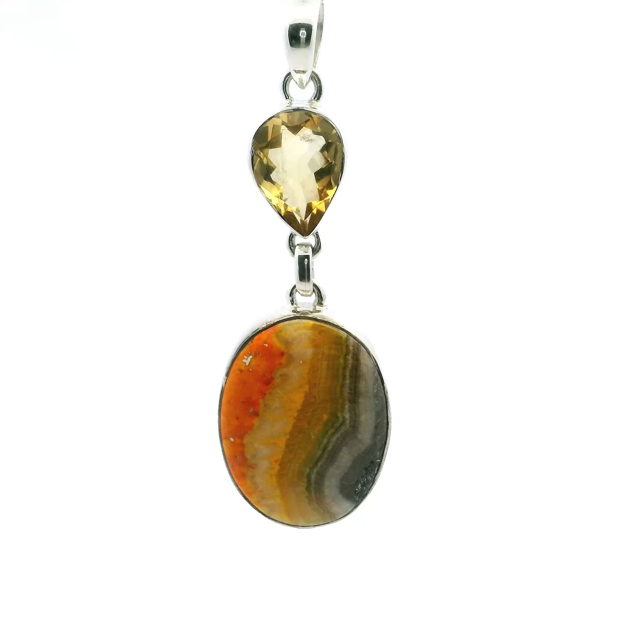 This eye-catching pendant features a vibrant oval Bumblebee Jasper cabochon with bold swirls of yellow, orange, and black, paired with an inverted faceted citrine teardrop that adds sparkle and warmth. Both stones are bezel-set in polished 925 sterling silver, creating a sleek, elegant frame.Striking and sophisticated, this pendant is perfect for those who appreciate unique gemstones and nature-inspired design—a standout piece for any occasion or jewelry collection. Bumblebee Jasper Pendant - Oval Cabochon Below Inverted Faceted Citrine Teardrop Bezel Set in 925 Sterling Silver