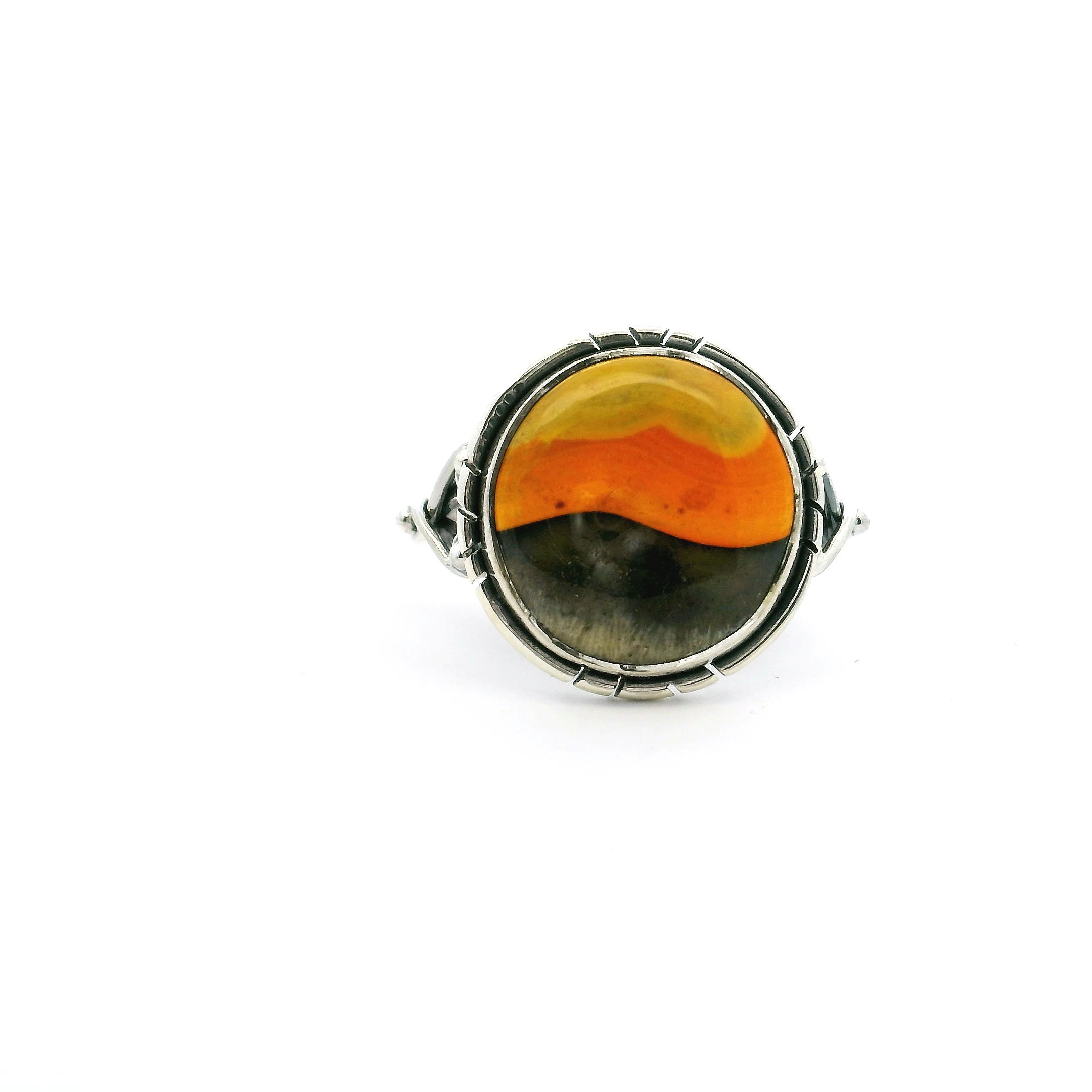 This size 8 ring features a vibrant round Bumblebee Jasper cabochon with striking bands of yellow, gray, and black—set in polished 925 sterling silver. A double band and delicate wishbone accents frame the stone, blending bold natural beauty with refined design.Perfect as a statement piece or everyday favorite, it’s a unique tribute to the power and elegance of the natural world—ideal for those who value craftsmanship and individuality. Bumblebee Jasper Ring - Round Tri-Color Cabochon With Double Band & Side Wishbone Accents Bezel Set In 925 Sterling Silver sz8