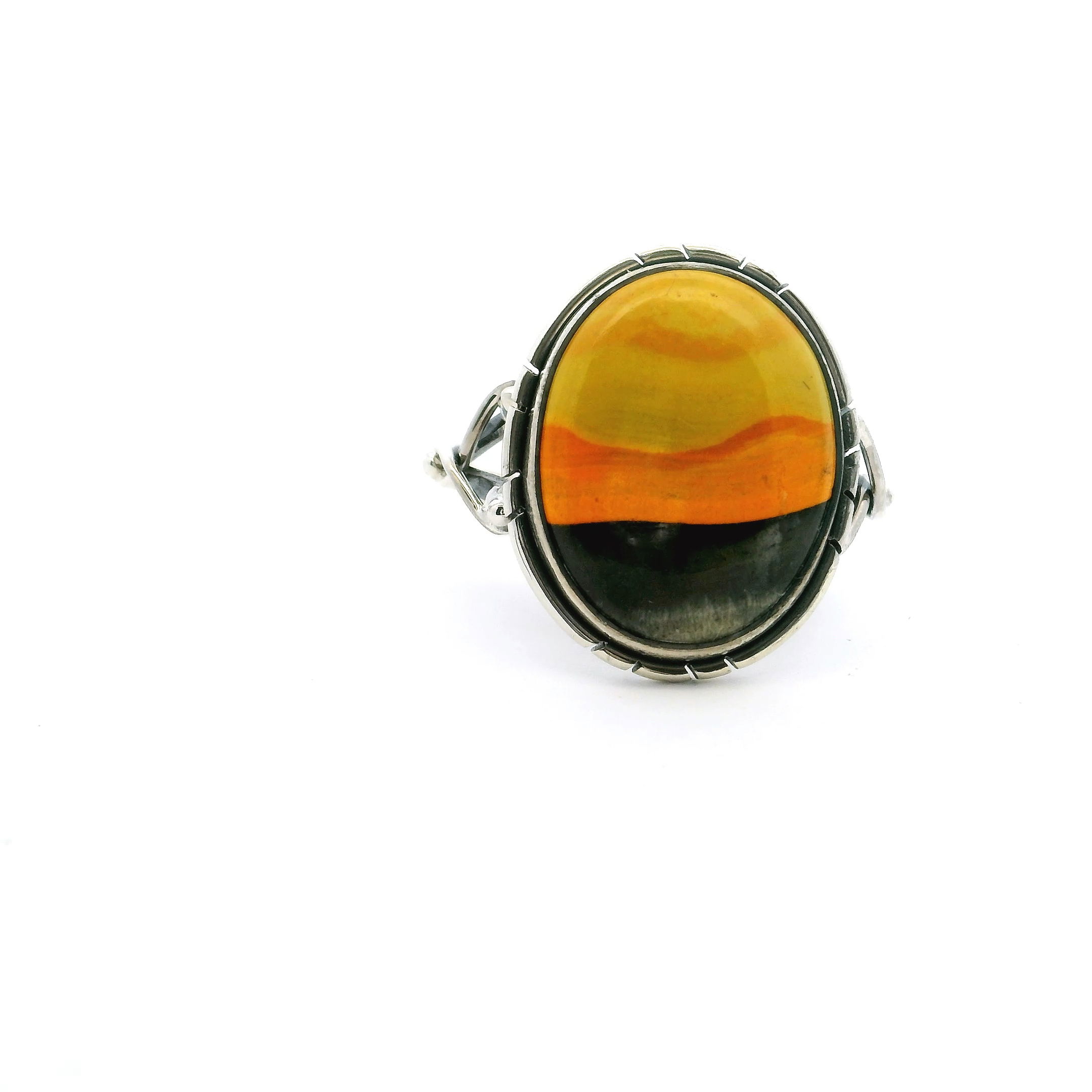 This eye-catching ring features an oval Bumblebee Jasper cabochon with vivid swirls of yellow, orange, and grey—bezel set in polished 925 sterling silver. A double band and beaded accents add modern elegance to this bold, tri-color stone.A vibrant, one-of-a-kind piece that brings natural energy and standout style to any jewelry collection. Bumblebee Jasper Ring - Oval Tri-color Cabochon with Double Band & Side Wishbone Accents Bezel Set in 925 Sterling Silver sz9