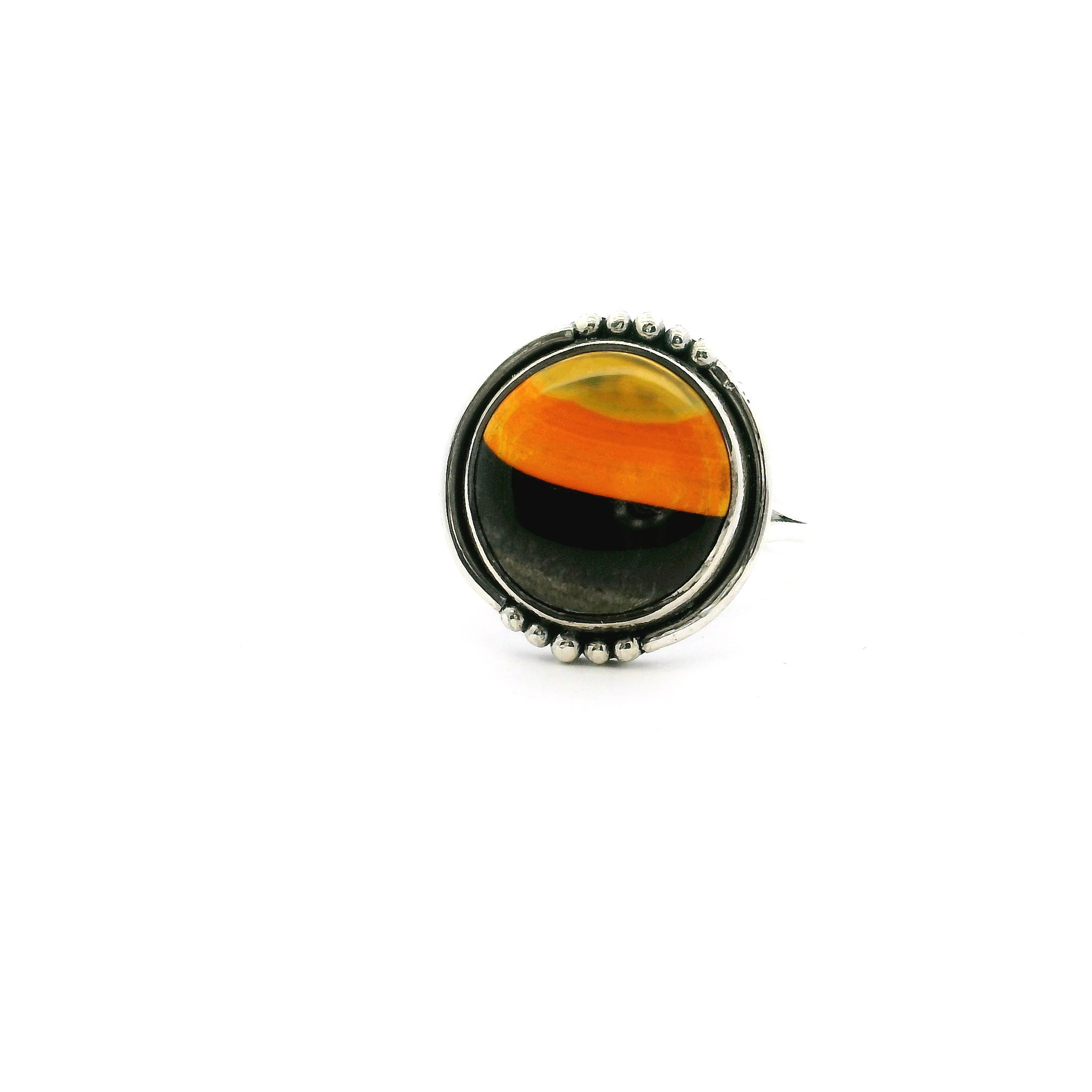 This vibrant size 7 ring features a round Bumblebee Jasper cabochon with natural swirls of yellow, orange, and gray—each stone uniquely patterned by nature. Set in 925 sterling silver, it’s accented with a double band and beaded bezel for added elegance and comfort.Perfect for everyday wear or special occasions, this ring blends bold color with timeless design—an ideal piece for anyone who loves distinctive, nature-inspired jewelry. Bumblebee Jasper Ring - Round Tri-color Cabochon with Double Band & Beaded Accents Bezel Set in 925 Sterling Silver sz7
