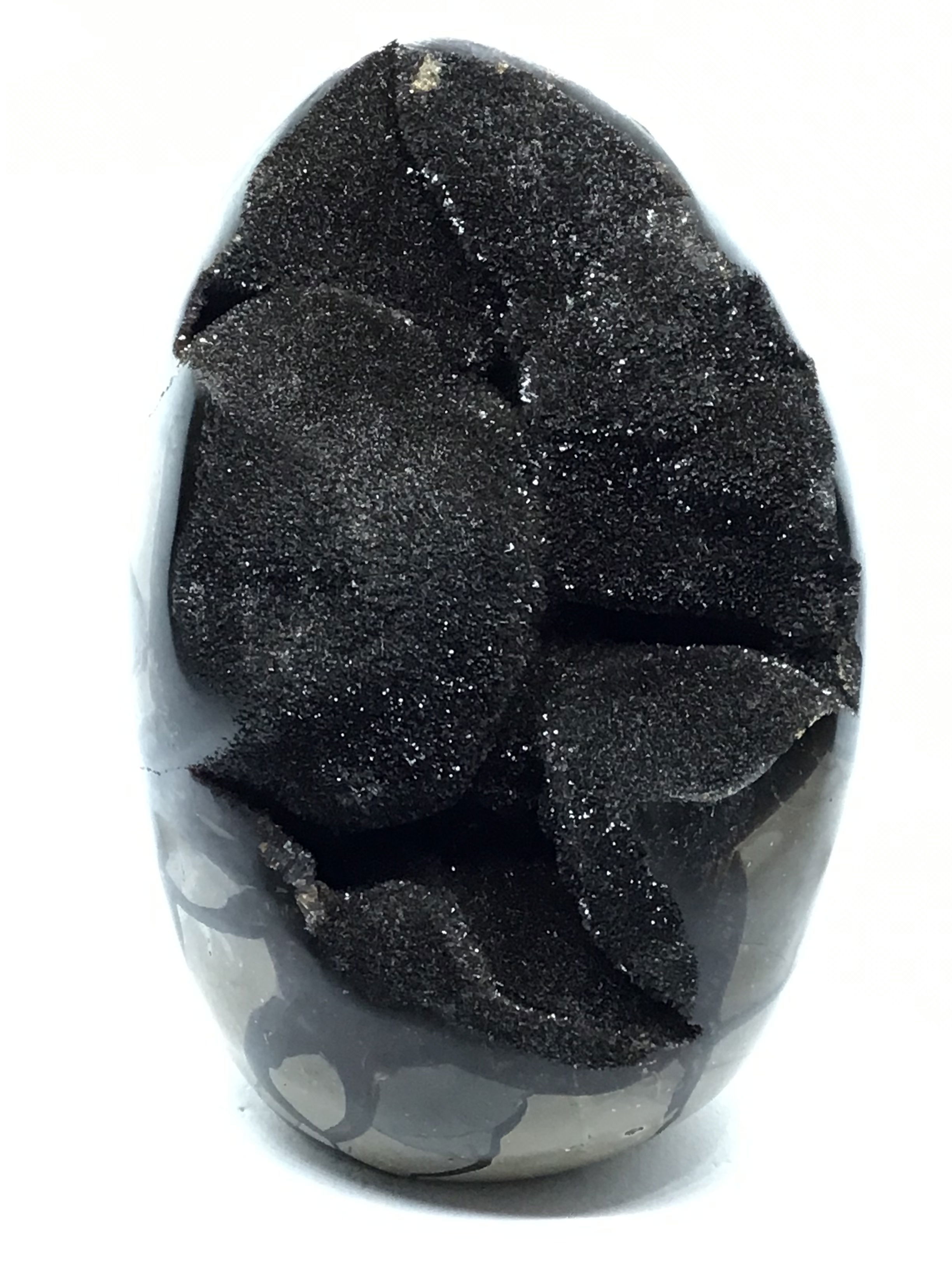 This freeform Septarian Geode Egg from Madagascar is a stunning showcase of natural geometry and sparkling druzy crystal detail. With its cut base for easy display, each piece reveals a unique blend of earthy patterns and shimmering calcite inclusions—formed over millions of years.Perfect for collectors, nature lovers, or as a distinctive decor accent, it brings grounding energy and quiet elegance to any space. A meaningful gift or personal treasure, it celebrates the timeless artistry of the natural world. Septarian Druze Geode Freeform Egg with Cut Base from Madagascar