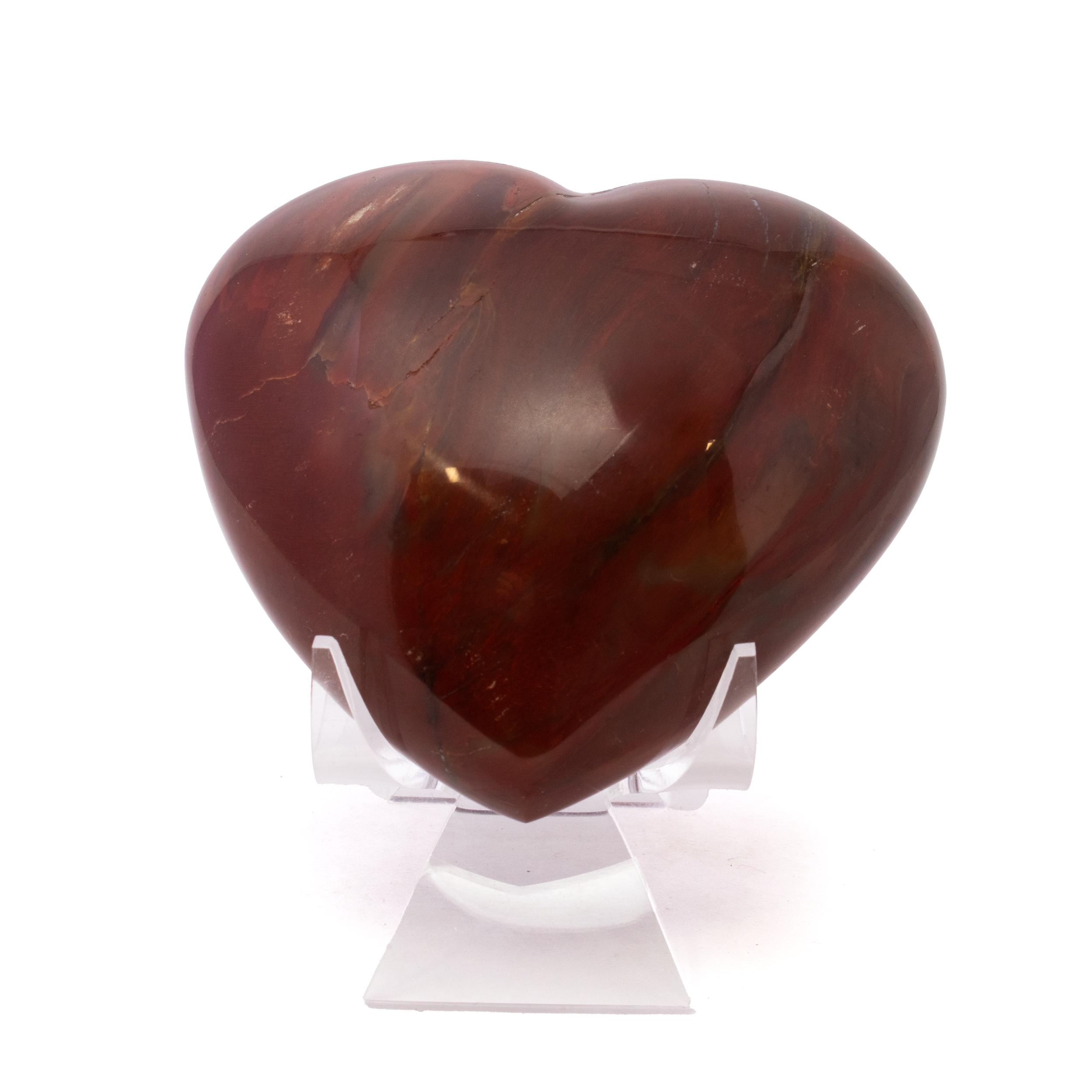 Carved from ancient petrified wood and shaped into a geometric heart, this piece from Madagascar reveals rich amber and chestnut tones with stunning natural grain. Fossilized over millions of years, it offers a striking blend of history, beauty, and sentiment.Paired with a clear lucite stand for elegant display, it’s a perfect gift or collector’s item—uniting Earth’s ancient past with a symbol of enduring love and natural artistry. Madagascar Petrified Wood Heart with Lucite Stand