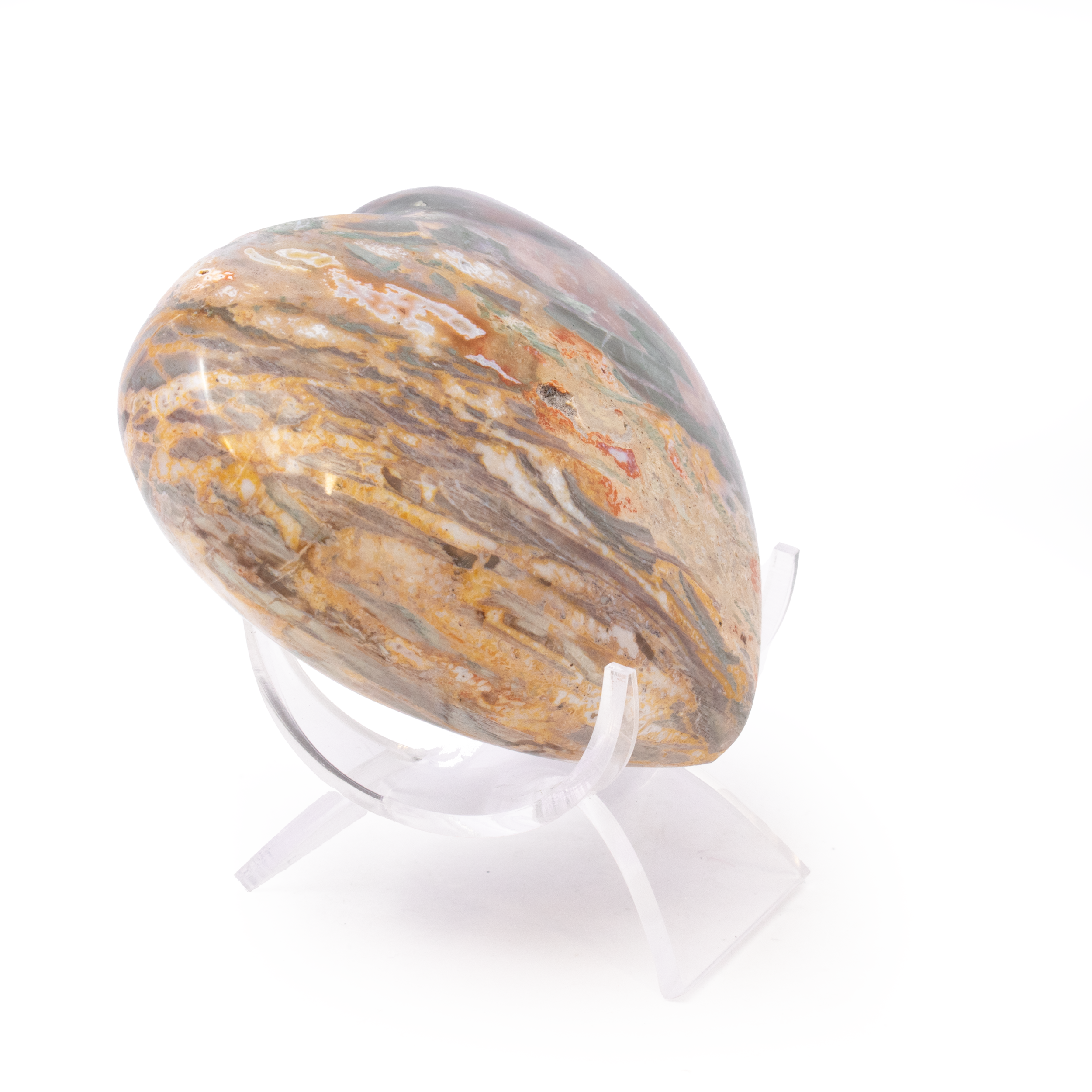 Formed over millions of years, this heart-shaped piece of petrified wood from Madagascar showcases rich green tones and unique patterns shaped by chromium deposits. Each one is truly one-of-a-kind, offering a glimpse into Earth’s ancient history.Displayed on a sleek lucite stand, it’s both a symbol of love and a stunning conversation piece—perfect for collectors, nature lovers, or anyone drawn to the timeless artistry of crystals and minerals. Madagascar Petrified Wood Heart with Lucite Stand - Unique Greens from Chromium