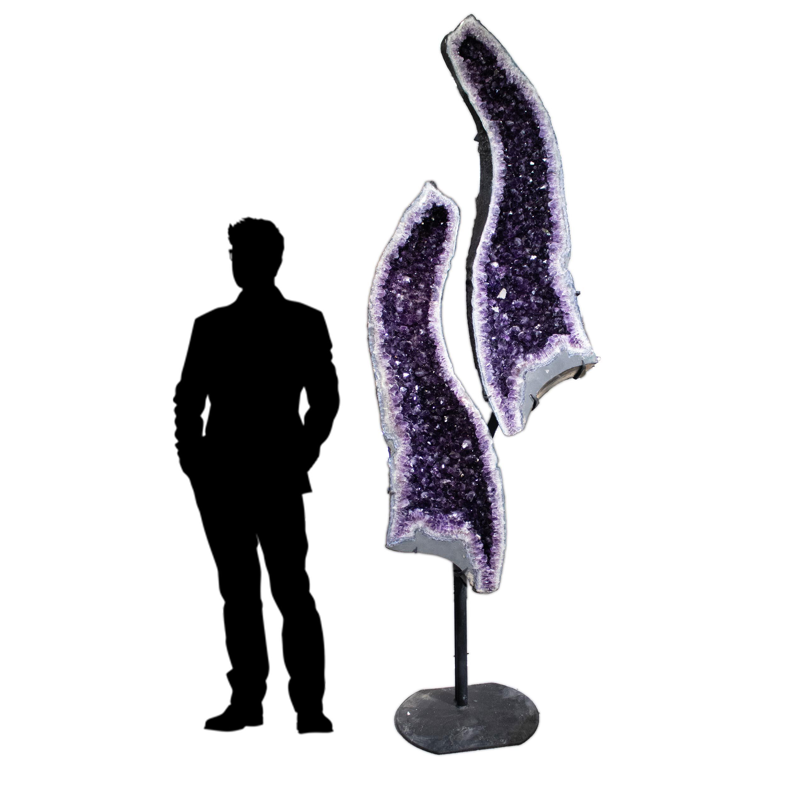 Experience the perfect harmony of nature and design with this Amethyst Geode Cathedral Pair from Brazil, presented in a striking Yin Yang alignment. Rich violet amethyst crystals shimmer with depth and intensity, complemented by radiant calcite inclusions that add a natural contrast of light and texture. Expertly cut and paired to mirror each other, the geodes rest in a custom-fitted stand that ensures stability and elegance.This remarkable specimen brings a tranquil yet powerful presence to any room, symbolizing balance and unity through its Yin Yang-inspired display. Ideal for collectors, interior designers, or anyone drawn to the calming energy of crystals, it serves as both a centerpiece and a spiritual focal point. Let this cathedral pair elevate your space with its timeless beauty and grounding energy. Amethyst Geode Cathedral Pait In Fitted Stand From Brazil With Calcite Crystal Inclusions - In Yin Yang Presentation
