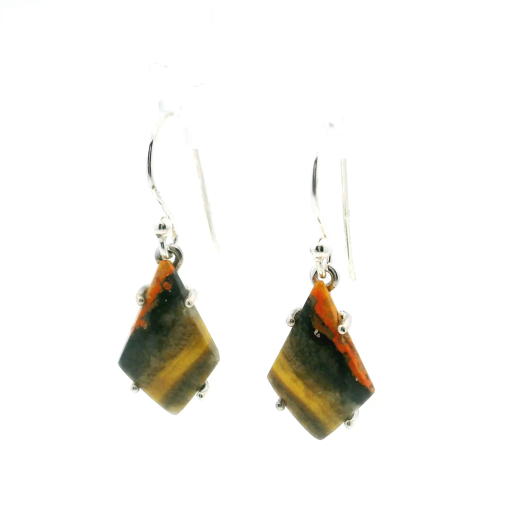 Embrace the captivating allure of natural elegance with our Bumblebee Jasper Dangle Earrings, featuring striking inverted kite cabochons that command attention with their dramatic banding of vivid yellows and deep blacks. Each stone is a geological work of art, its angled patterning revealing the raw, untamed energy of volcanic earth and mineral-rich deposits. Carefully prong-set in high-polish 925 sterling silver, the setting provides a clean, modern frame that enhances the stone’s bold contrast while ensuring secure, all-day wear.Thoughtfully designed for fluid movement and luminous shine, these earrings sway gracefully with every step, catching the light and highlighting the dynamic beauty of the jasper. Their sleek silhouette and statement-making color palette make them ideal for both everyday sophistication and elevated evening wear. Whether gifted or self-chosen, these Bumblebee Jasper earrings celebrate individuality and craftsmanship, offering a powerful expression of personal style through the beauty of nature’s artistry. Bumblebee Jasper Dangle Earrings - Inverted Kite Cabochon with Angled Yellow & Black Banding Prong Set in 925 Steling Silver