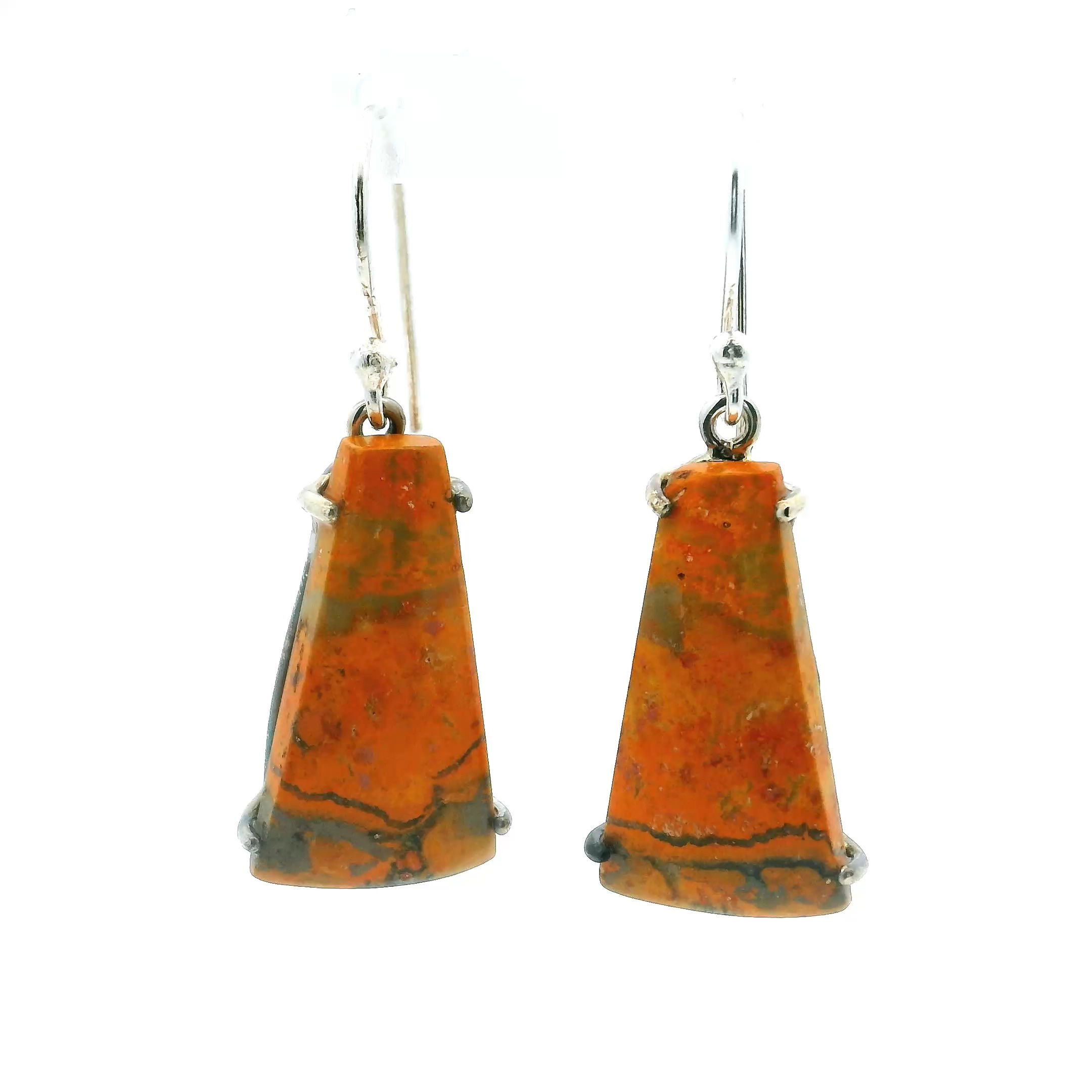 Bumblebee Jasper Dangle Earrings offer a striking blend of natural vibrancy and refined craftsmanship. Featuring bold ladder trapezoid cabochons with vivid orange tones and intricate black webbing, each stone is prong-set in polished 925 sterling silver to accentuate its one-of-a-kind pattern.Designed with a graceful dangle silhouette, these earrings move with subtle elegance, making them a perfect statement for both everyday wear and special occasions. A distinctive addition to any jewelry collection, they reflect an appreciation for bold beauty and timeless style. Bumblebee Jasper Dangle Earrings - Ladder Trapezoid Cabochon with Orange Background & Black Webbing Prong Set in 925 Sterling Silver