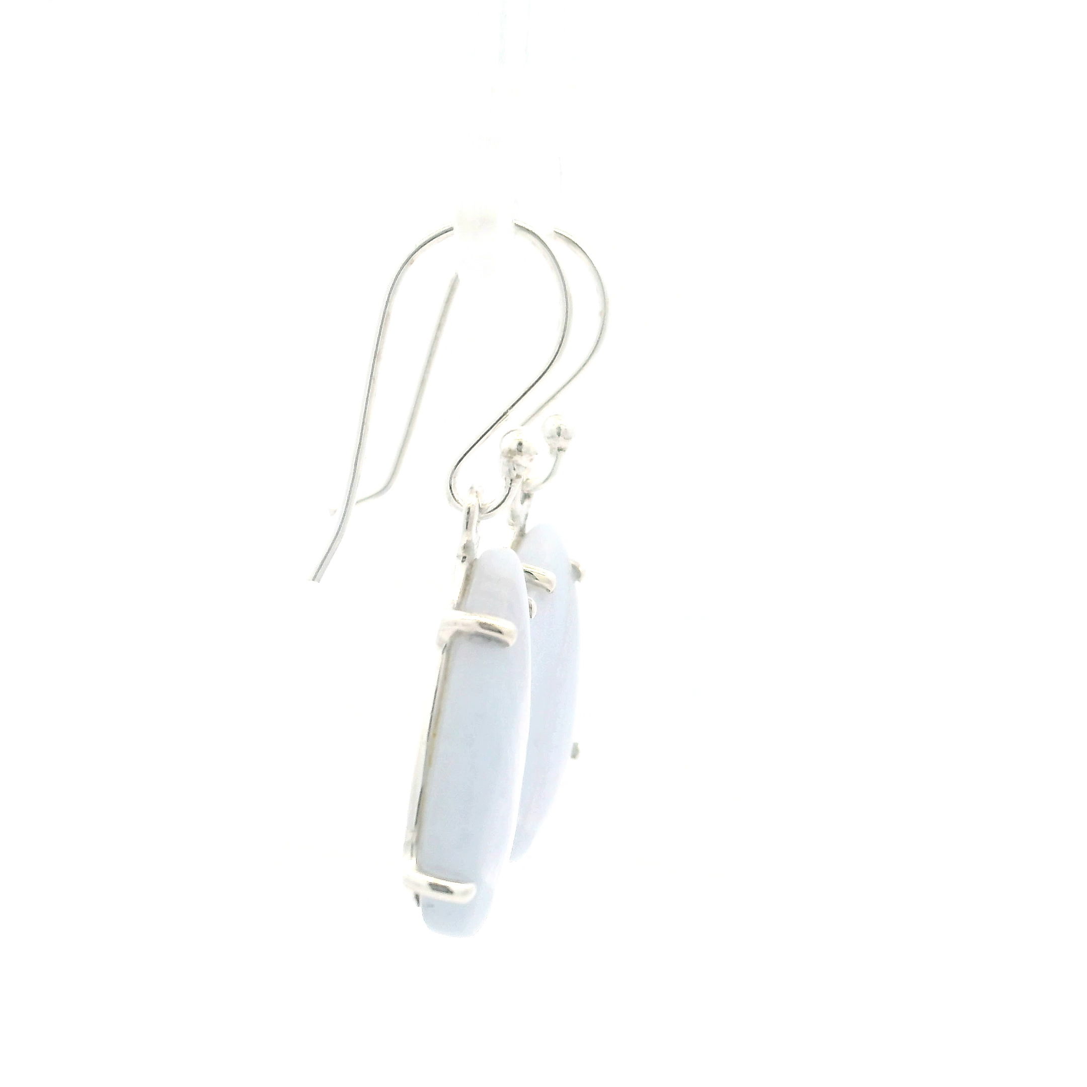 Blue Lace Agate Dangle Earrings offer a serene touch of elegance with teardrop cabochons prong-set in polished 925 sterling silver. Each stone reveals soft blue hues layered with darker vertical banding, creating a tranquil yet refined look that complements any style.The graceful dangle silhouette adds gentle movement and timeless charm, making these earrings perfect for both everyday wear and special occasions. Crafted for comfort and lasting beauty, they bring the calming energy of Blue Lace Agate into your collection with effortless sophistication. Blue Lace Agate Dangle Earrings - Teardrop Cabochon with Darker Vertical Banding Prong Set in 925 Sterling Silver