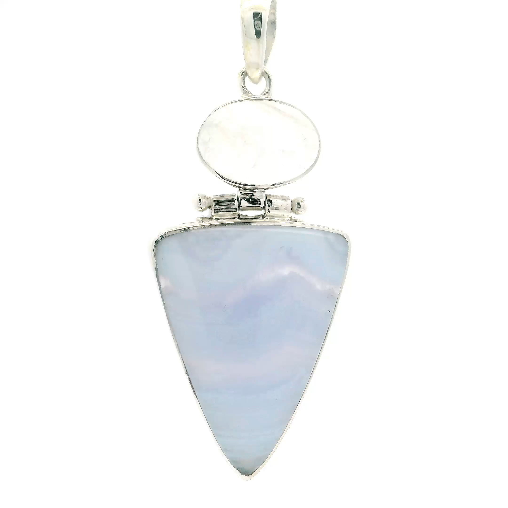 Celebrate the calming beauty of natural gemstones with our Blue Lace Agate Pendant, featuring an inverted triangular cabochon of soft, sky-blue agate marked by delicate horizontal banding. Paired with a luminous oval Rainbow Moonstone, this pendant evokes the tranquility of open skies and the ethereal glow of moonlight. Together, the stones create a striking balance of grounded serenity and mystical elegance.Both cabochons are expertly bezel set in polished 925 sterling silver, ensuring durability and refined detail. The harmonious design offers versatility—equally stunning worn solo or layered—making it an ideal piece for everyday grace or special occasions. A meaningful gift or a treasured keepsake, this pendant is a quiet statement of style, peace, and individuality. Blue Lace Agate Pendant - Inverted Triangular Cabochon with Horizontal Banding below Oval Rainbow Moonstone Cabochon Bezel Set in 925 Sterling Silver