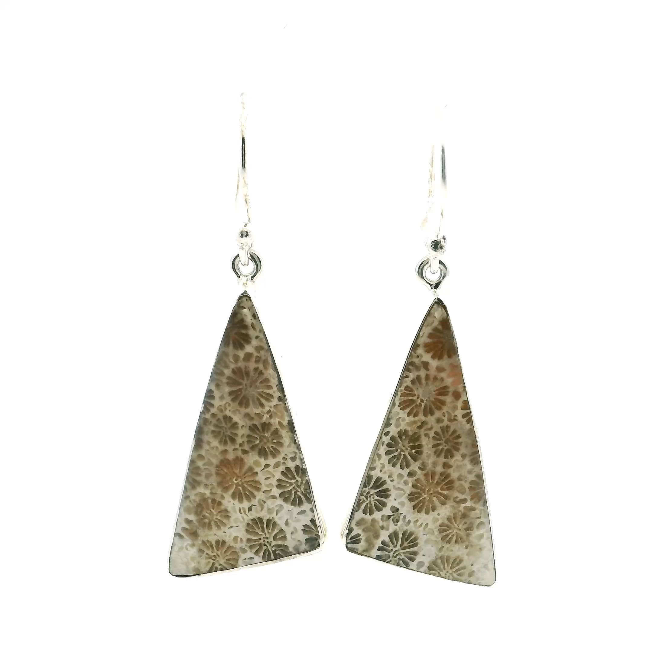 The Fossilized Coral Dangle Earrings feature a triangular cabochon of genuine fossilized coral, bezel set in sleek 925 sterling silver. Each earring showcases unique, intricate patterns that speak to the ancient beauty of natural history, making them a standout addition to any jewelry collection.These earrings bring an earthy charm to modern elegance, with graceful movement that captures light and highlights the organic beauty of the fossilized coral. Ideal for both casual and formal occasions, they offer a perfect blend of nature’s artistry and refined design. Fossilized Coral Dangle Earrings - Triangular Cabochon Bezel Set in Simple 925 Sterling Silver