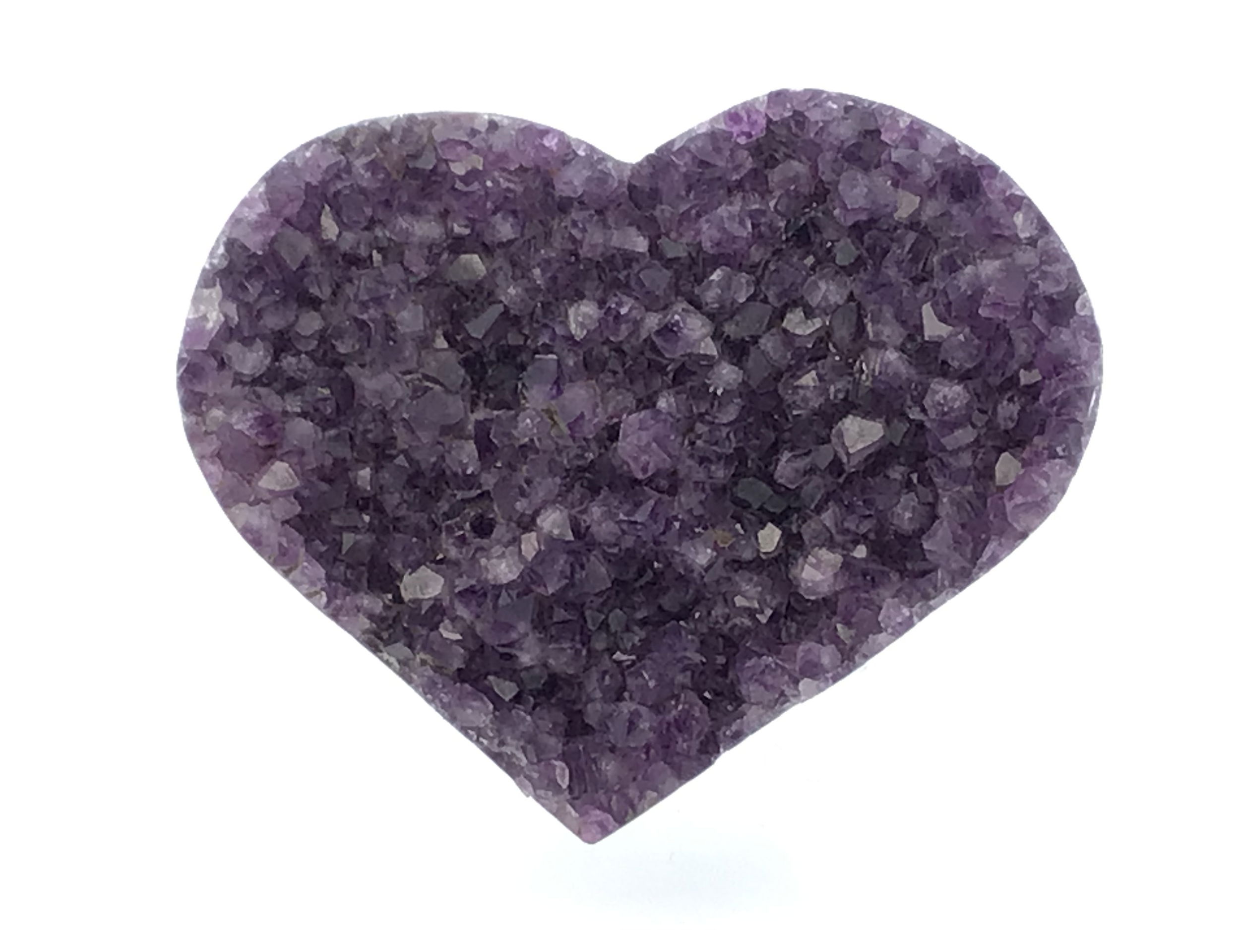 The Amethyst Crystal Heart on Lucite Cluster Stand brings together the calming energy of natural amethyst and the modern elegance of a geometric lucite base, forming a radiant centerpiece for any space. Carved into a perfect heart, the deep violet crystal catches and reflects light with a soft inner glow, symbolizing emotional balance and spiritual clarity.Elevated on a transparent lucite stand that gives the illusion of weightlessness, the amethyst appears to float, creating a sense of serenity and grace. Ideal for desks, shelves, or sacred spaces, this piece adds both beauty and positive energy wherever it's placed. A thoughtful gift or a refined addition to any crystal collection, the Amethyst Crystal Heart on Lucite Cluster Stand is a timeless expression of love, peace, and the natural magic of the mineral world. Amethyst Crystal Heart on Lucite Cluster Stand