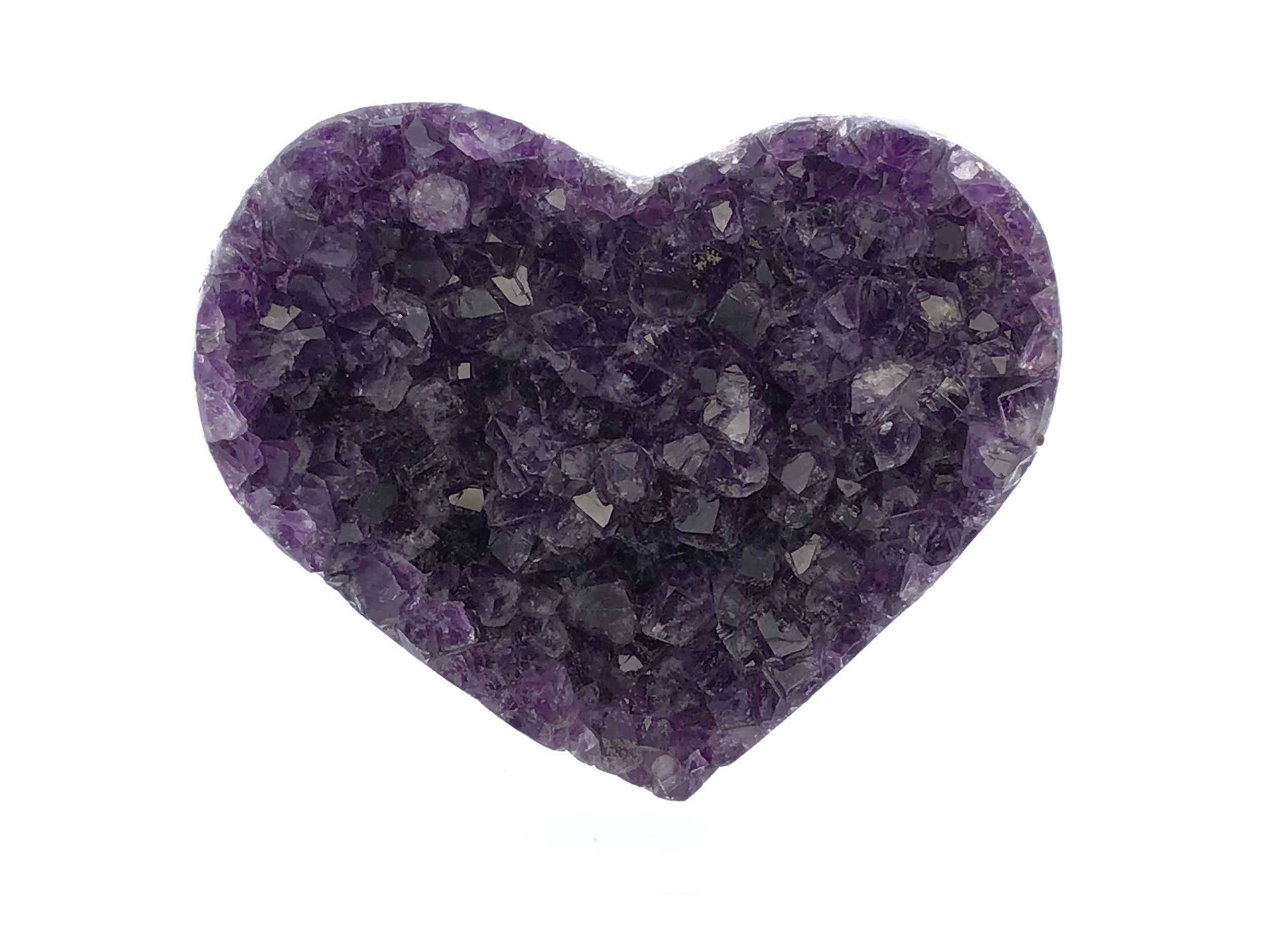 The Amethyst Crystal Heart on Lucite Cluster Stand brings together the calming energy of natural amethyst and the modern elegance of a geometric lucite base, forming a radiant centerpiece for any space. Carved into a perfect heart, the deep violet crystal catches and reflects light with a soft inner glow, symbolizing emotional balance and spiritual clarity.Elevated on a transparent lucite stand that gives the illusion of weightlessness, the amethyst appears to float, creating a sense of serenity and grace. Ideal for desks, shelves, or sacred spaces, this piece adds both beauty and positive energy wherever it's placed. A thoughtful gift or a refined addition to any crystal collection, the Amethyst Crystal Heart on Lucite Cluster Stand is a timeless expression of love, peace, and the natural magic of the mineral world. Amethyst Crystal Heart on Lucite Cluster Stand