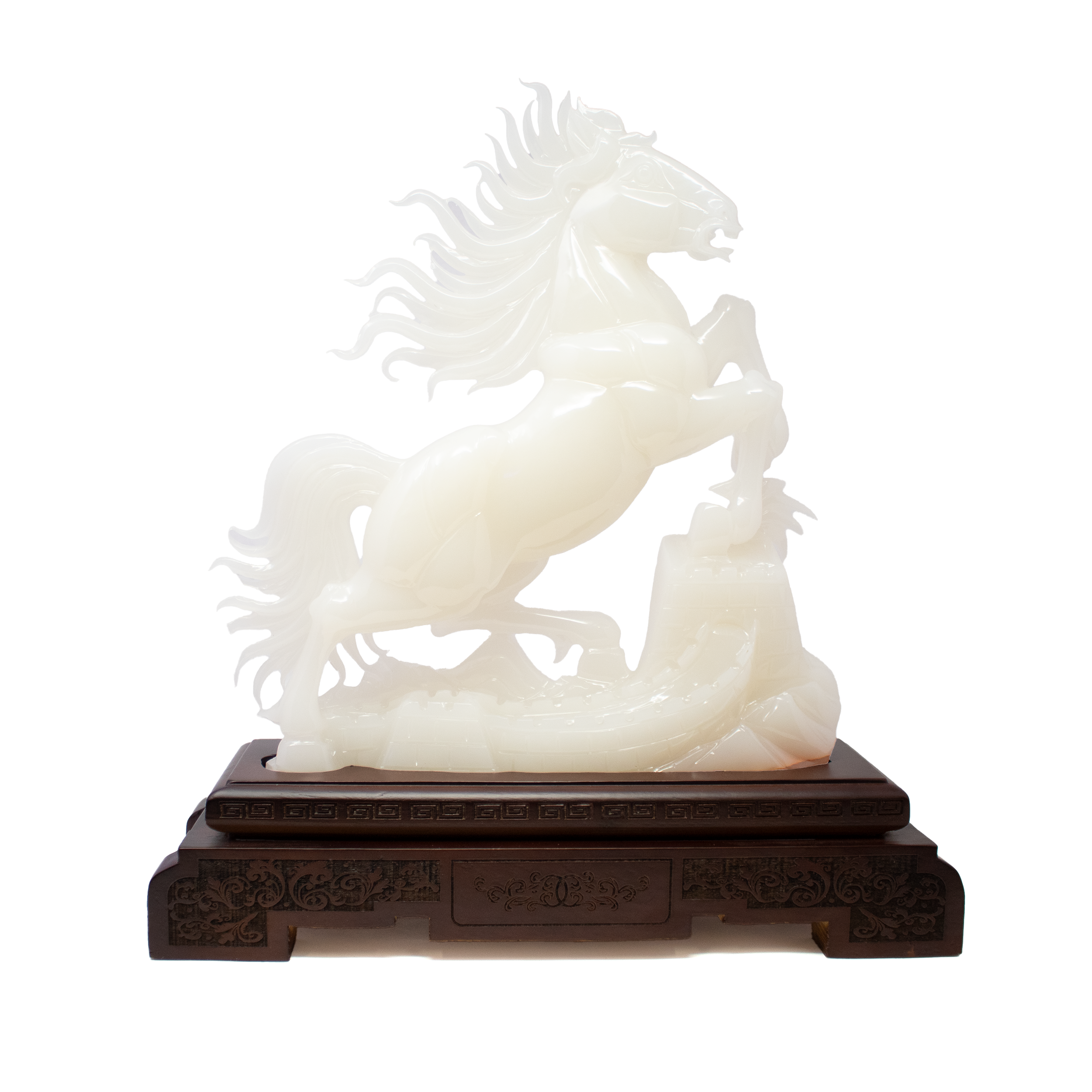 A radiant symbol of strength and legacy, this White Onyx Horse Carving with Great Wall Feature unites natural beauty with traditional Chinese craftsmanship. Hand-carved in China from luminous white onyx, the sculpture captures the dynamic motion of the horse with flowing lines and carefully rendered musculature, while a subtle depiction of the Great Wall along its flank adds depth, history, and symbolism—representing resilience, protection, and cultural pride. The reverse side reveals the natural beauty of the stone & wood with no carving.Resting atop a finely carved wooden base, the cool translucence of the stone is beautifully offset by the base’s warm grain, grounding the sculpture and enhancing its visual impact. No two pieces are identical; the natural veining of the onyx ensures that each carving is as individual as it is meaningful. A++ White Onyx Horse Carving with Great Wall Feature on Carved Wooden Base from China