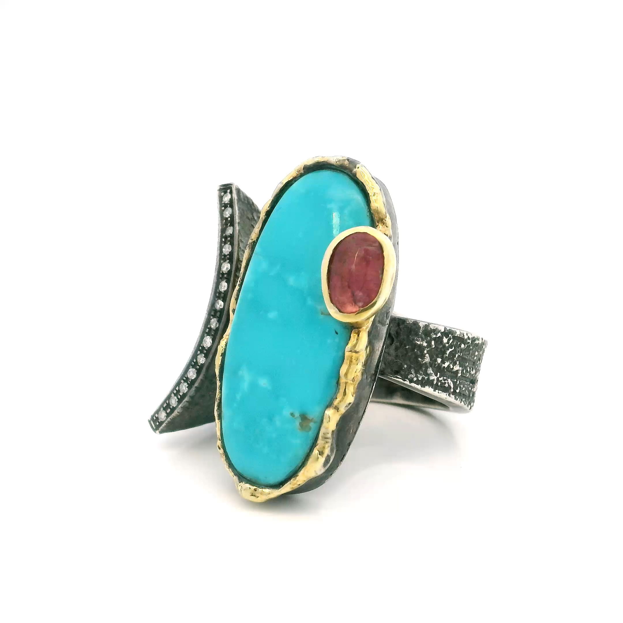 Experience the captivating beauty of the Southwest with our Arizona Turquoise Ring, masterfully crafted for the modern woman who loves a touch of artistry. This striking piece showcases a long oval cabochon of vivid Arizona turquoise, its signature sky-blue hues bezel set at the center of attention. Nestled opposite, a sparkling faceted oval pink tourmaline lends a romantic pop of color, both stones set in glowing 925 sterling silver.The open band design creates an intriguing asymmetry, highlighted by a graceful curve adorned with a single row of pave-set diamonds for dazzling brilliance. Elegant dripped gold accents add a luxurious, organic feel to the setting, seamlessly merging classic craftsmanship with contemporary style. Whether worn alone as a statement piece or stacked with your favorite rings, this size 8 ring is the perfect addition to any jewelry collection. Celebrate individuality and timeless elegance with this unique Arizona Turquoise and Pink Tourmaline ring—a true embodiment of artisan jewelry. Arizona Turquoise Ring - Long Oval Cabochon & Faceted Pink Tourmaline Oval on Open Band with Curved Single Row Pave Diamonds & Dripped Gold Accents Bezel Set in 925 Sterling Silver sz8