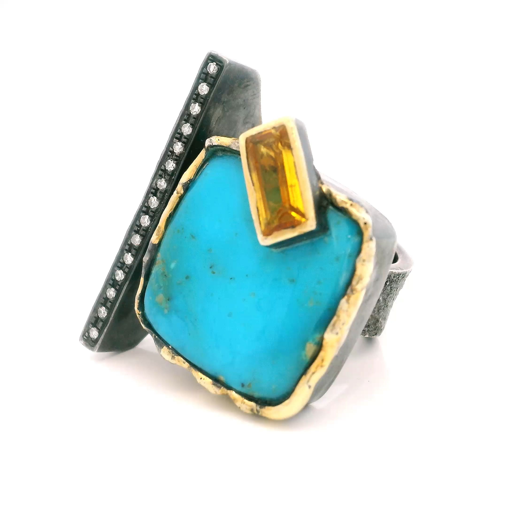 A striking fusion of Southwestern charm and modern glamour, this Arizona Turquoise Ring showcases a captivating square turquoise cabochon paired with a sparkling faceted rectangle citrine. Both gems are bezel-set on an open 925 sterling silver band, accented by a single row of pavé diamonds that add subtle brilliance.Distinctive dripped gold details provide an artisanal touch, emphasizing the vibrant contrast between stones. Sized at 7, this ring is a bold statement piece for women who value unique, meticulously crafted jewelry. Arizona Turquoise Ring - Square Cabochon & Faceted Citrine Rectangle on Open Band with Single Row Pave Diamonds & Dripped Gold Accents Bezel Set in 925 Sterling Silver sz7