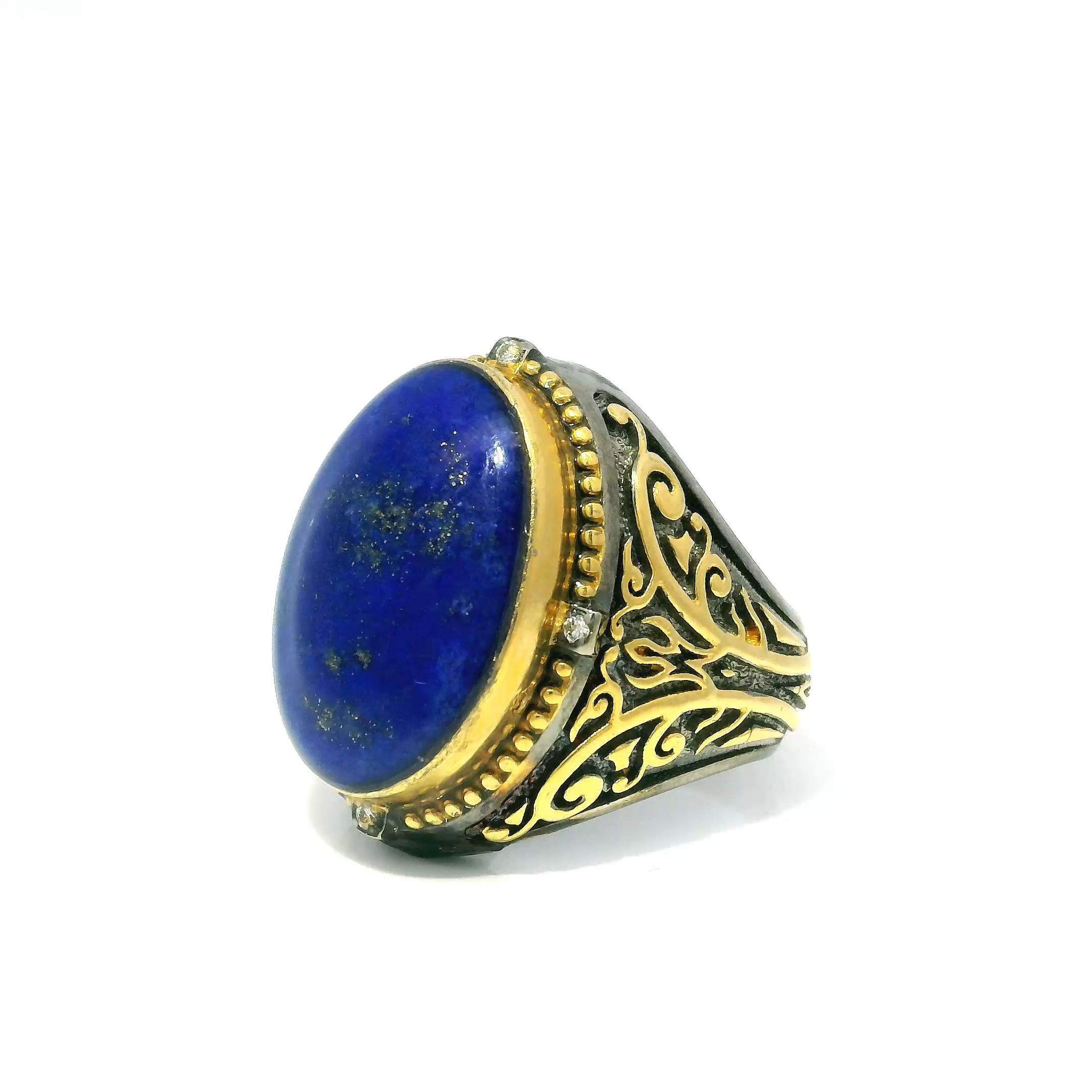 Elevate your style with this enchanting Lapis Lazuli Ring, meticulously crafted to blend timeless sophistication with whimsical charm. The centerpiece is a mesmerizing oval cabochon of deep blue lapis, rich with natural golden flecks that evoke a star-strewn night sky. Four brilliant diamonds accentuate the stone, adding a touch of luminous sparkle to every movement.Ornate butterfly detailing flanks each side, symbolizing transformation and elegance, while shimmering gold accents enhance the intricately sculpted bezel. Expertly forged in 925 sterling silver and designed in size 9, this ring is a bold and refined statement—perfect for those who appreciate artistry, symbolism, and the natural beauty of gemstones. Lapis Lazuli Ring - Oval Cabochon with 4 Diamonds & Side Ornate Butterfly Detail Bezel Set with Gold Accents in 925 Sterling Silver sz9
