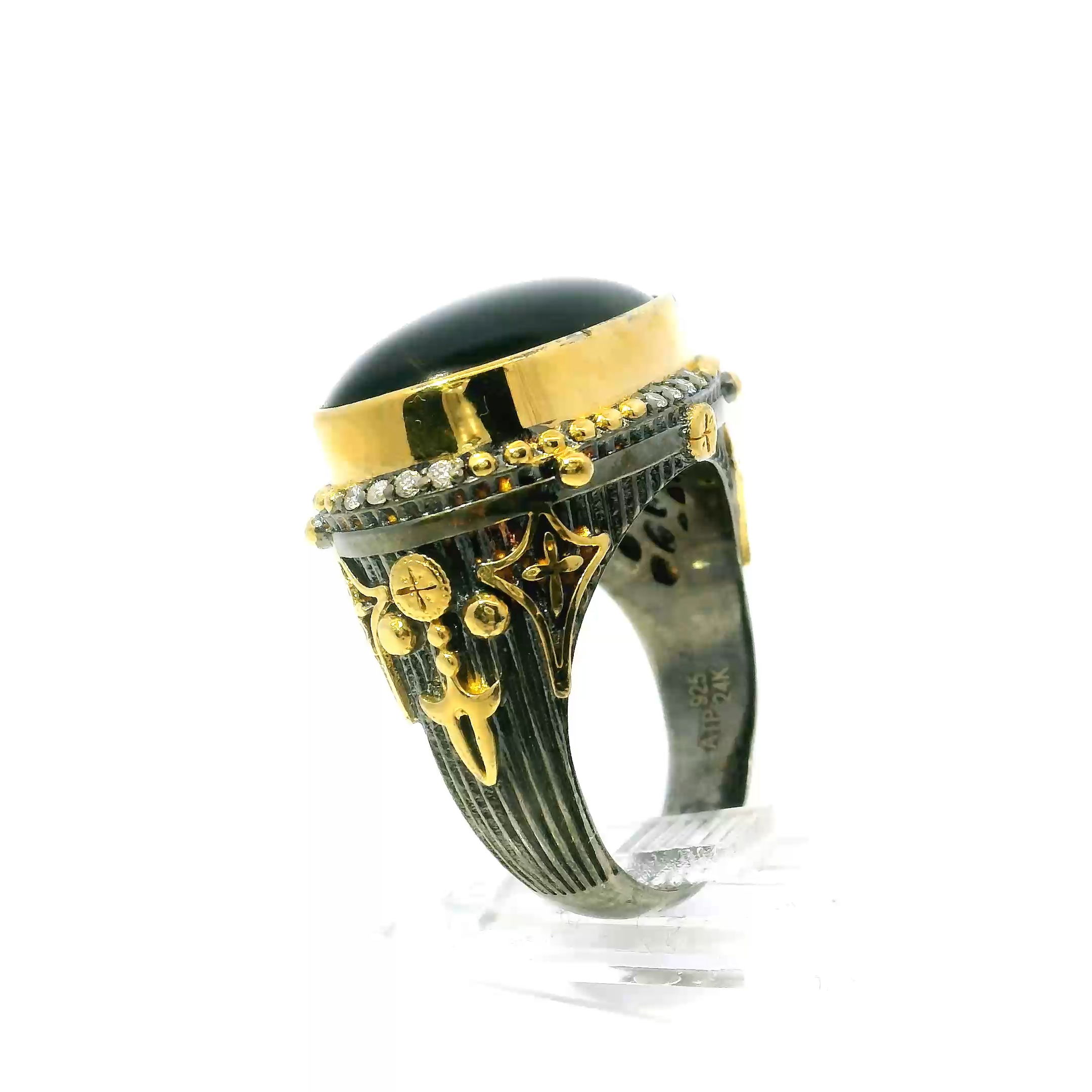 Elevate your style with this striking Black Onyx Ring, featuring a rich oval cabochon set east-west in premium 925 sterling silver. The deep black onyx is beautifully framed by a constellation of 16 sparkling diamonds, while unique gold star and bead accents add a radiant celestial touch.Sized at 9.5, the sleek sterling silver band balances bold sophistication with timeless charm, making this ring perfect for statement looks alone or layered with other favorites. An unforgettable addition to any jewelry collection. Black Onyx Ring - East-West Oval Cabochon & 16 Diamonds Bezel Set in 925 Sterling Silver with Gold Star & Bead Accents sz9.5