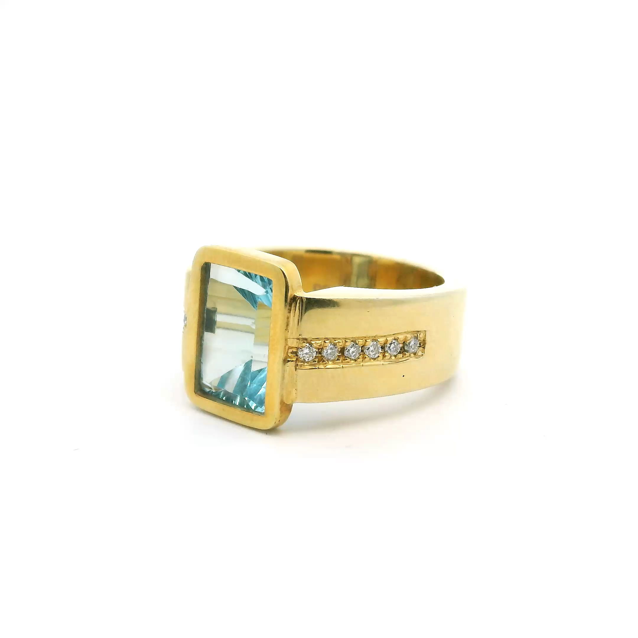 Elevate your style with this stunning Blue Topaz Ring, designed to captivate at every glance. The centerpiece features a faceted rectangular blue topaz, bezel-set and flush within a band of luxurious gold vermeil over solid 925 sterling silver.Sparkling diamonds cascade down both sides of the band, adding radiant brilliance and sophisticated detail. Perfectly sized at 9.5, this ring is the epitome of modern elegance, ideal for any jewelry lover’s collection—whether worn daily or reserved for special occasions. Blue Topaz Ring - Faceted Rectangle with Diamonds Down Both Sides of Band Bezel Set Flush in Gold Vermeil over 925 Sterling Silver sz9.5