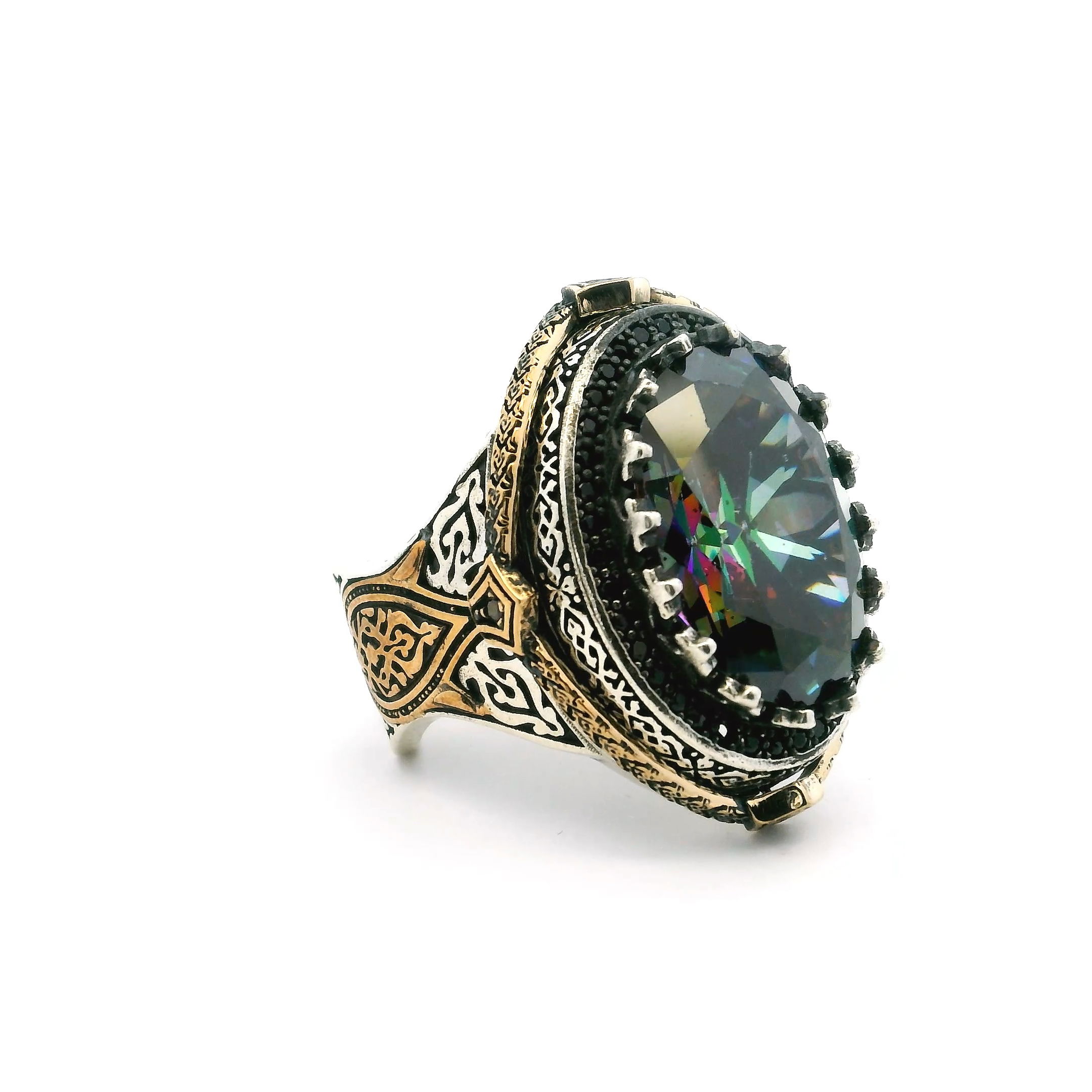 Elevate your style with this striking Mystic Topaz Ring, expertly crafted for those who appreciate bold, modern design. The centerpiece is a mesmerizing faceted oval mystic topaz, its iridescent hues shifting with every movement, secured in an ornate sawtooth setting that adds avant-garde artistry.Encircling the topaz, a single row of hand-set black nanostones creates dramatic contrast and edgy sophistication. Fashioned from premium 925 sterling silver and finished with rich gold vermeil, this ring offers durability and luxury. Available in sizes 8.5 and 10, it’s perfect for making a statement—whether worn alone or paired with other favorites. Mystic Topaz Ring - Faceted Oval in Designer Sawtooth Setting with Single Row Pave Black Nanostones in 925 Sterling Silver with Gold Vermeil sz8.5