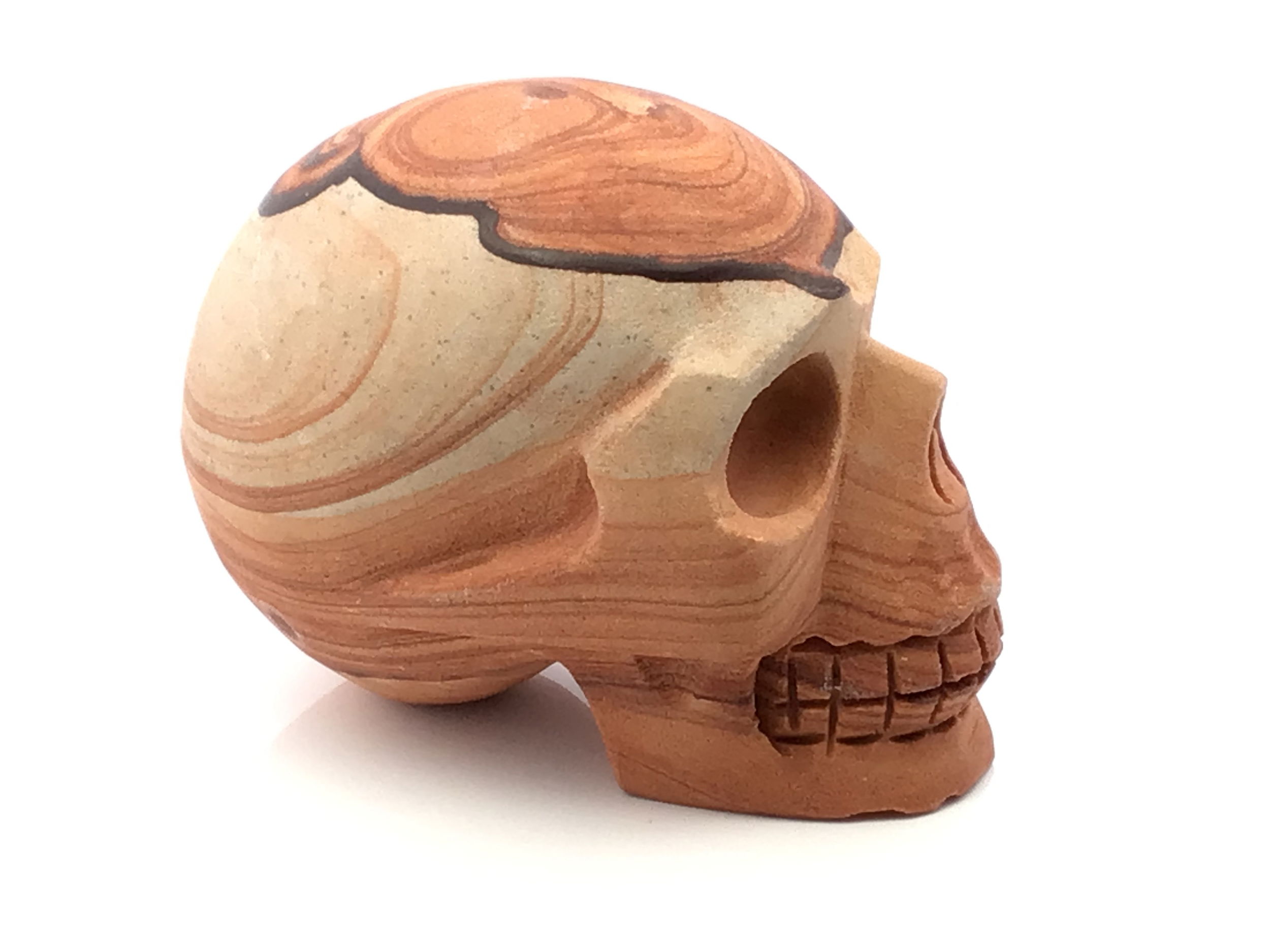Hand-carved from genuine desert sandstone, this skull sculpture captures the raw essence of arid landscapes with its earthy textures and windswept hues. Each piece is naturally unique, with subtle variations in warm taupe, dusty rose, and sun-bleached beige, reflecting the ancient terrain it hails from. Intricately detailed and sculpted to evoke the mystery of timeworn relics, this piece makes a striking accent in any setting.Whether placed on a bookshelf, mantle, or covered patio, it blends effortlessly into rustic, bohemian, or modern interiors. Ideal for skull collectors, desert lovers, or those drawn to bold, naturalistic art, this Desert Sandstone Skull Carving is both a tribute to nature’s artistry and a timeless statement of individuality. Desert Sandstone Skull Carving