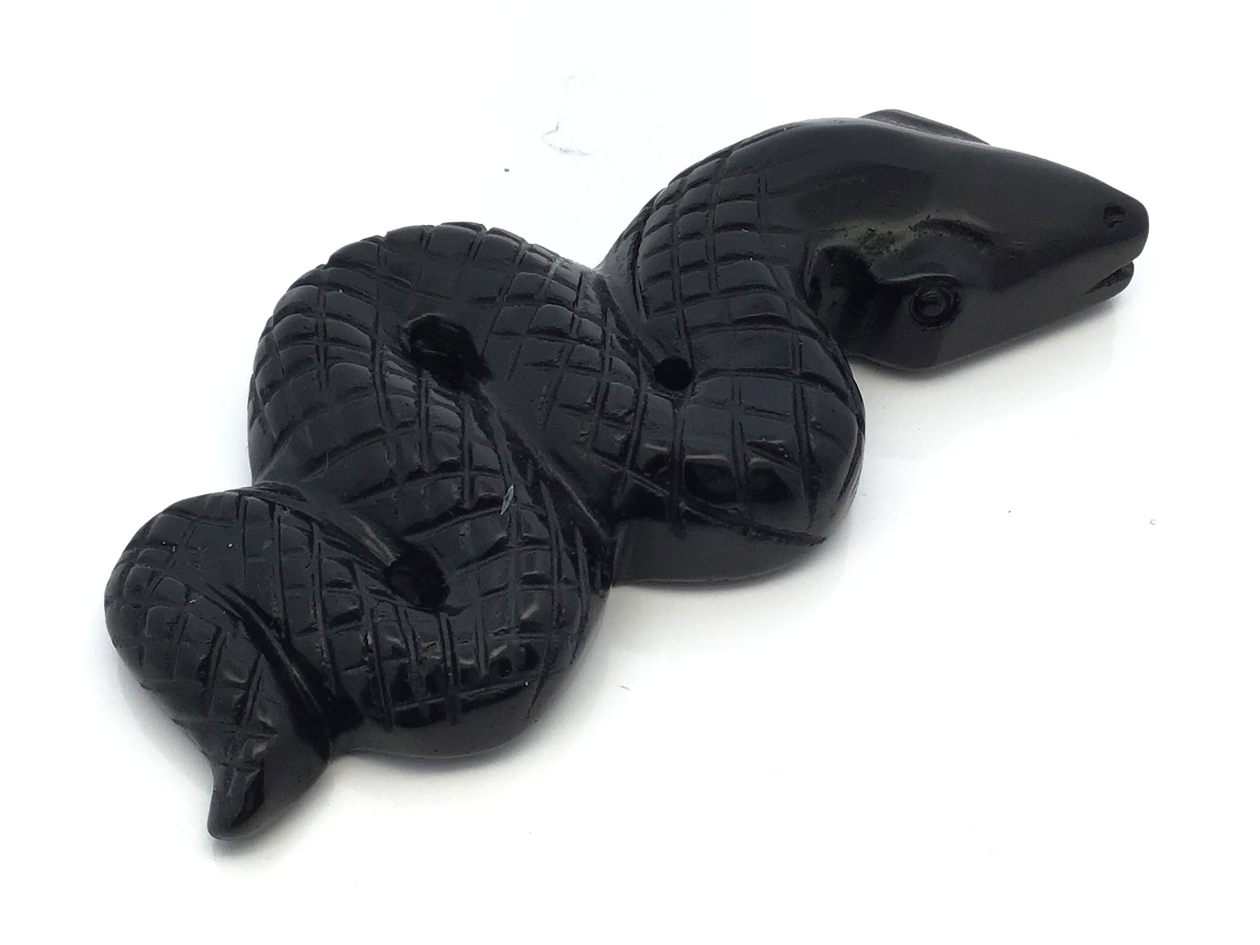 Handcrafted from genuine black obsidian, this 4-inch snake carving captures the poised tension of a serpent ready to strike, its sleek volcanic glass surface shimmering with a rich, deep luster. Every scale and curve is meticulously detailed, embodying transformation, rebirth, and protective energy.Perfectly sized for display on desks, shelves, or altars, this striking piece serves as both a powerful talisman and an elegant accent. Thoughtfully packaged, it makes a meaningful gift for collectors, spiritual seekers, or anyone drawn to symbols of courage and awakening. Black Obsidian 4" Snake Ready-to-Strike Carving