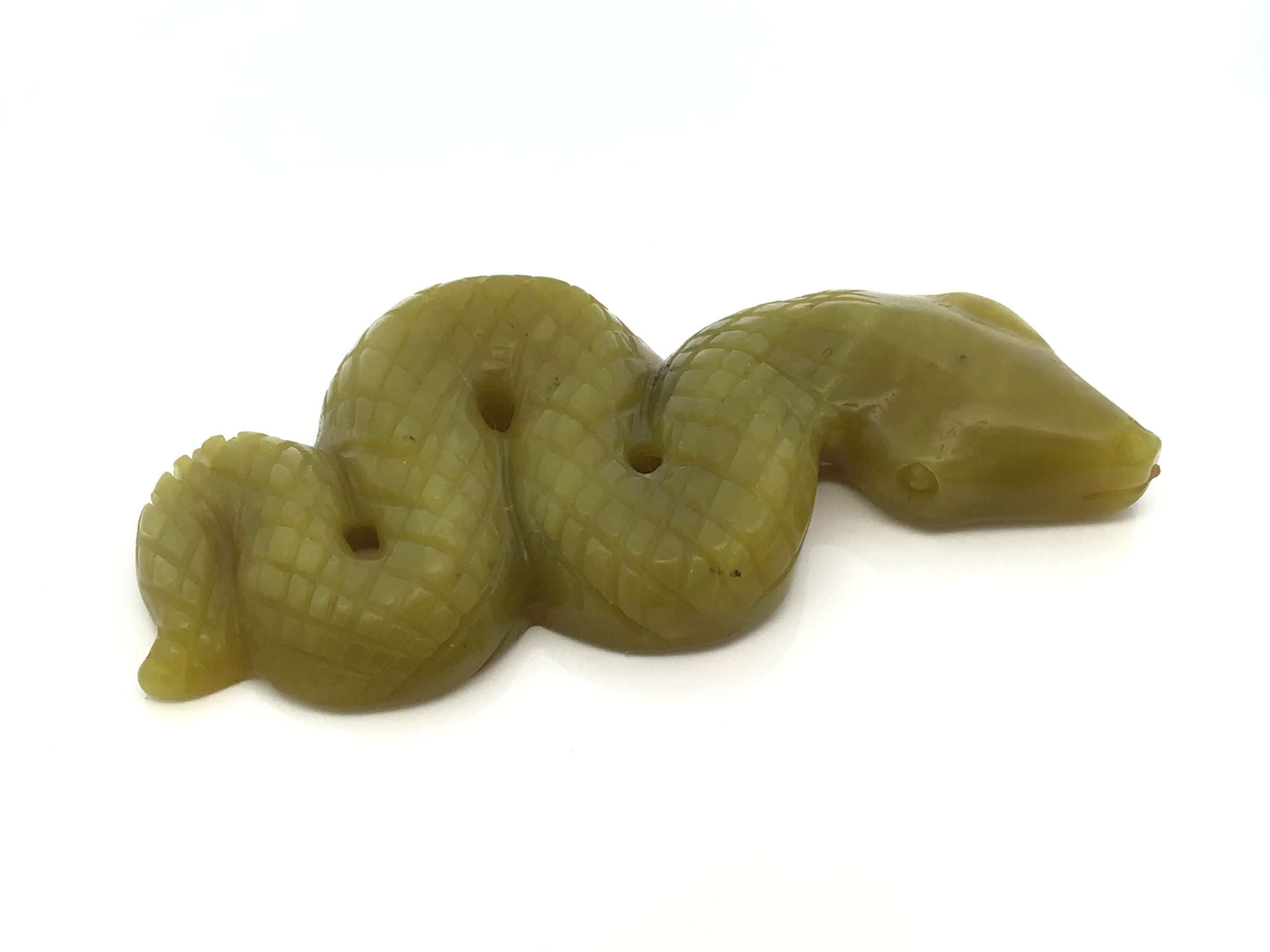 The Lemon Jade 4" Snake Ready-to-Strike Carving embodies poised energy and graceful transformation in pale yellow jade. Handcrafted with expert precision, this sculpture captures the tense alertness of a snake moments before it strikes, symbolizing wisdom, protection, and new beginnings. The smooth, luminous jade surface highlights delicate details of scales and curves, making each piece uniquely vibrant and elegant.Ideal as a striking accent for home or office décor, or as a meaningful gift, this carving brings serene vitality and symbolic depth to any collection. Measuring 4 inches long, it stands as a testament to masterful craftsmanship and timeless natural beauty. Lemon Jade 4" Snake Ready-to-Strike Carving