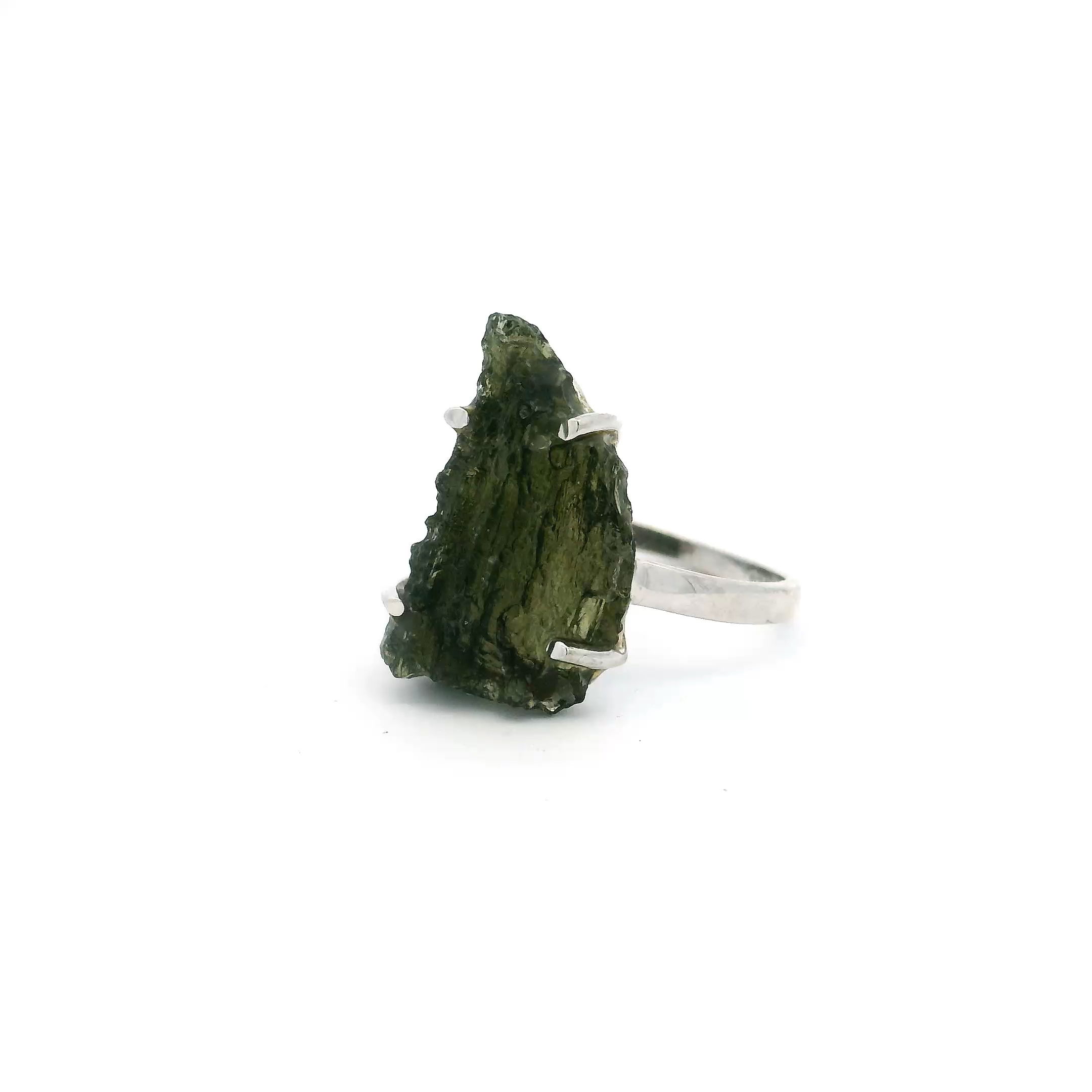 Elevate your style with this unique Moldavite Ring, artfully shaped to mirror the bold outline of Arizona. The freeform Moldavite gemstone is prong-set in genuine 925 sterling silver, its natural edges preserved to highlight the stone’s raw beauty and extraterrestrial origin. Designed in size 6, the rich, mossy green tones of Moldavite bring depth and intrigue to this handcrafted piece.Mystical and meaningful, this ring blends the magic of the Southwest with the transformative energy Moldavite is known for. A one-of-a-kind treasure for any collection, it makes a thoughtful gift or a powerful personal talisman for those drawn to rare gems and bold design. Moldavite Ring - Arizona Shaped Freeform Prong Set in 925 Sterling Silver sz6