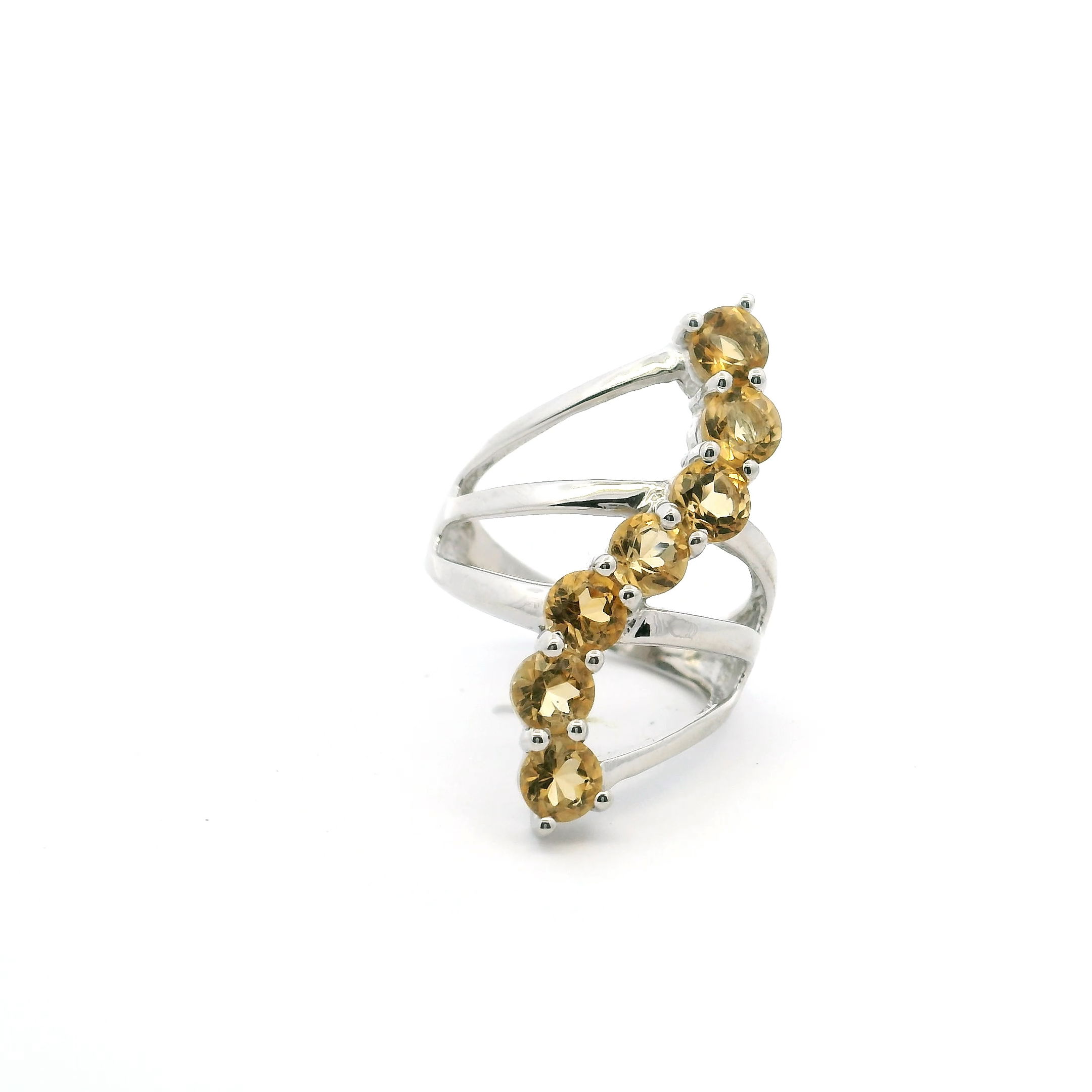 This Citrine Ring features seven faceted round citrines arranged in a subtle S-shaped curve on a triple band of polished 925 sterling silver. Sized at 5, it balances bold color with clean, modern lines.The prong setting enhances each stone’s natural sparkle, making the ring both durable and eye-catching. Its design suits everyday wear or special occasions, perfect for anyone looking to add a refined pop of golden warmth to their collection. Citrine Ring - 7 Faceted Rounds in S-Shaped Design on Triple Band Prong Set in 925 Sterling Silver sz5