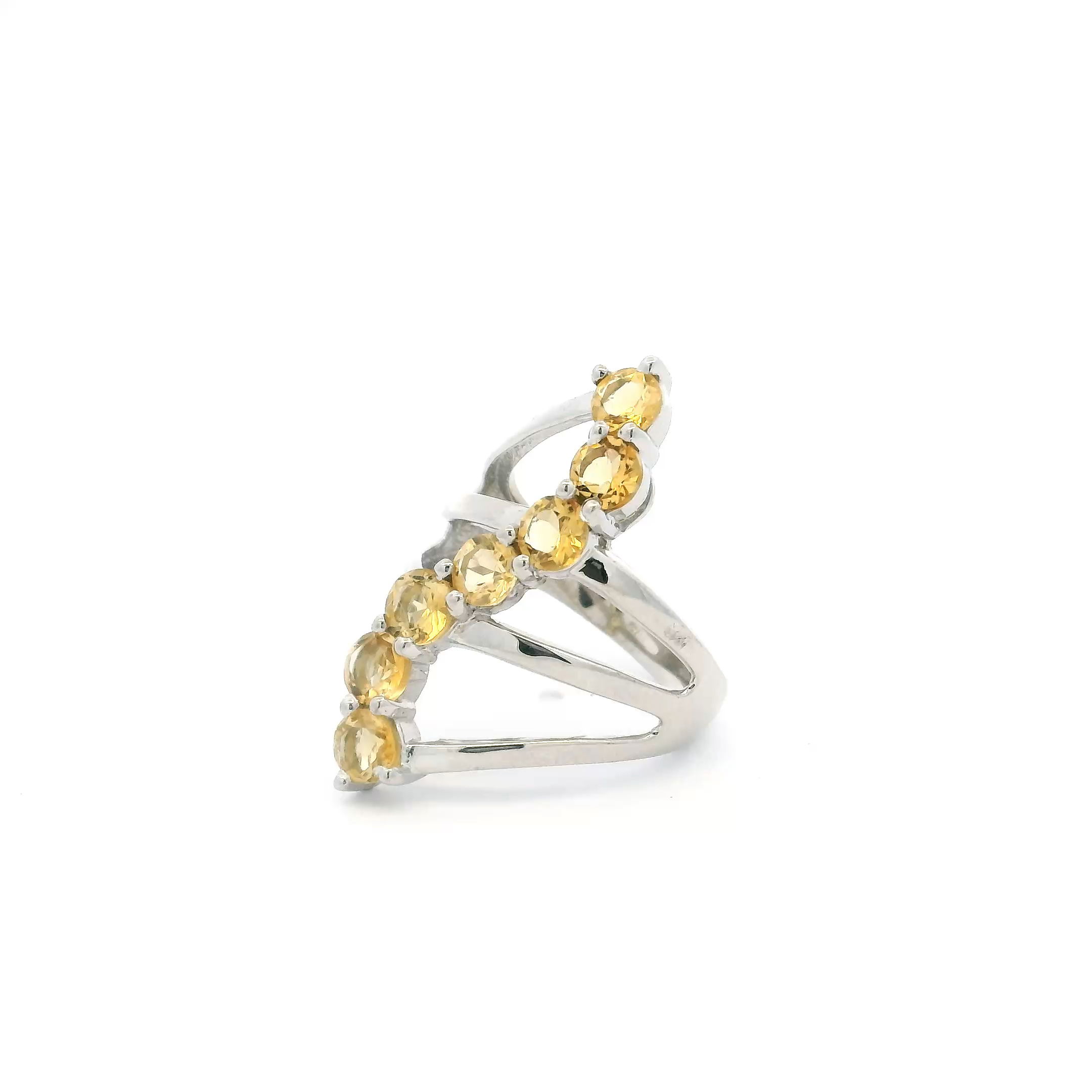 Radiate effortless elegance with this Citrine Ring featuring seven brilliantly faceted round citrine gemstones arranged in a graceful S-shaped design. Expertly prong-set on a triple band of high-polish 925 sterling silver, this size 6 ring combines modern sophistication with timeless beauty. The vibrant yellow hues of the citrine stones catch the light from every angle, making it the perfect accessory to brighten any outfit. Sized for an ideal fit, this ring is an exquisite choice for women's jewelry collections, special occasions, or as a thoughtful gift for someone who loves unique, eye-catching pieces. Citrine Ring - 7 Faceted Rounds in S-Shaped Design on Triple Band Prong Set in 925 Sterling Silver sz6