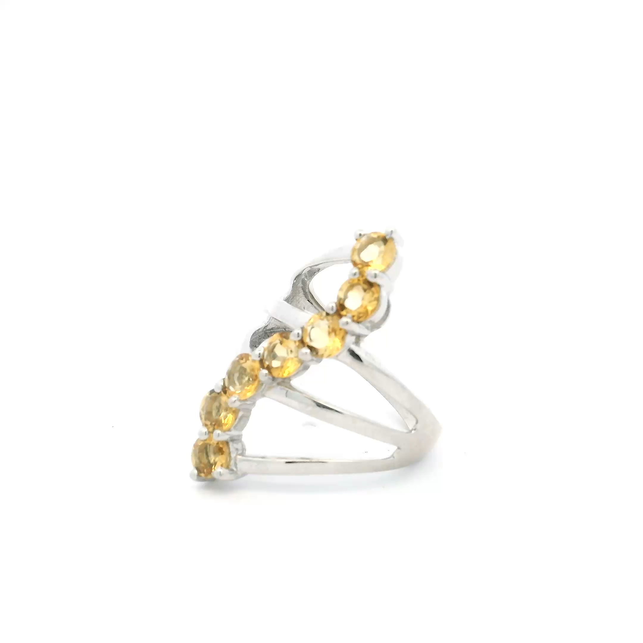 The Citrine Ring showcases seven faceted round citrine gemstones arranged in a fluid S-shaped design, balancing boldness with refined elegance. Each vibrant stone is prong set to maximize sparkle, while the triple-band silhouette in genuine 925 sterling silver offers both durability and modern flair. Crafted for a size 7 fit, this ring is perfect for women who love distinctive jewelry with a touch of sunshine. Whether worn alone or stacked with other favorites, this citrine ring is a striking statement piece for any jewelry collection. Citrine Ring - 7 Faceted Rounds in S-Shaped Design on Triple Band Prong Set in 925 Sterling Silver sz7