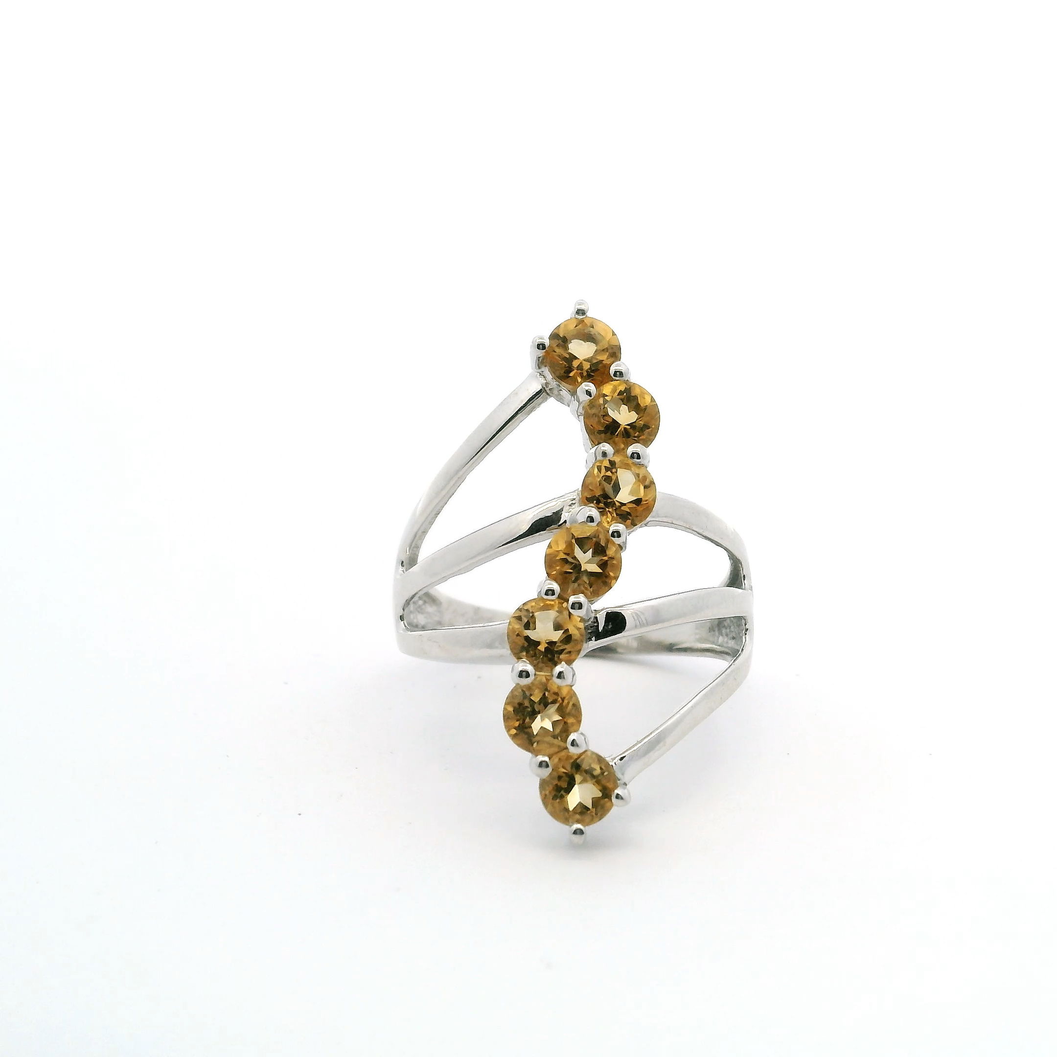 Radiate warmth and elegance with this captivating Citrine Ring, featuring seven stunning faceted round citrines skillfully arranged in a graceful S-shaped design. Each vibrant gemstone is prong set to maximize sparkle, beautifully showcased on a triple band crafted from premium 925 sterling silver. The unique triple band combines strength with modern flair, while the polished silver finish enhances the golden hues of the citrines.Designed in a comfortable size 8, this ring blends sophisticated style with a burst of color, making it a perfect statement piece for any jewelry collection. Ideal for birthdays, anniversaries, or simply treating yourself, it celebrates every moment with the bold brilliance of citrine. Citrine Ring - 7 Faceted Rounds in S-Shaped Design on Triple Band Prong Set in 925 Sterling Silver sz8